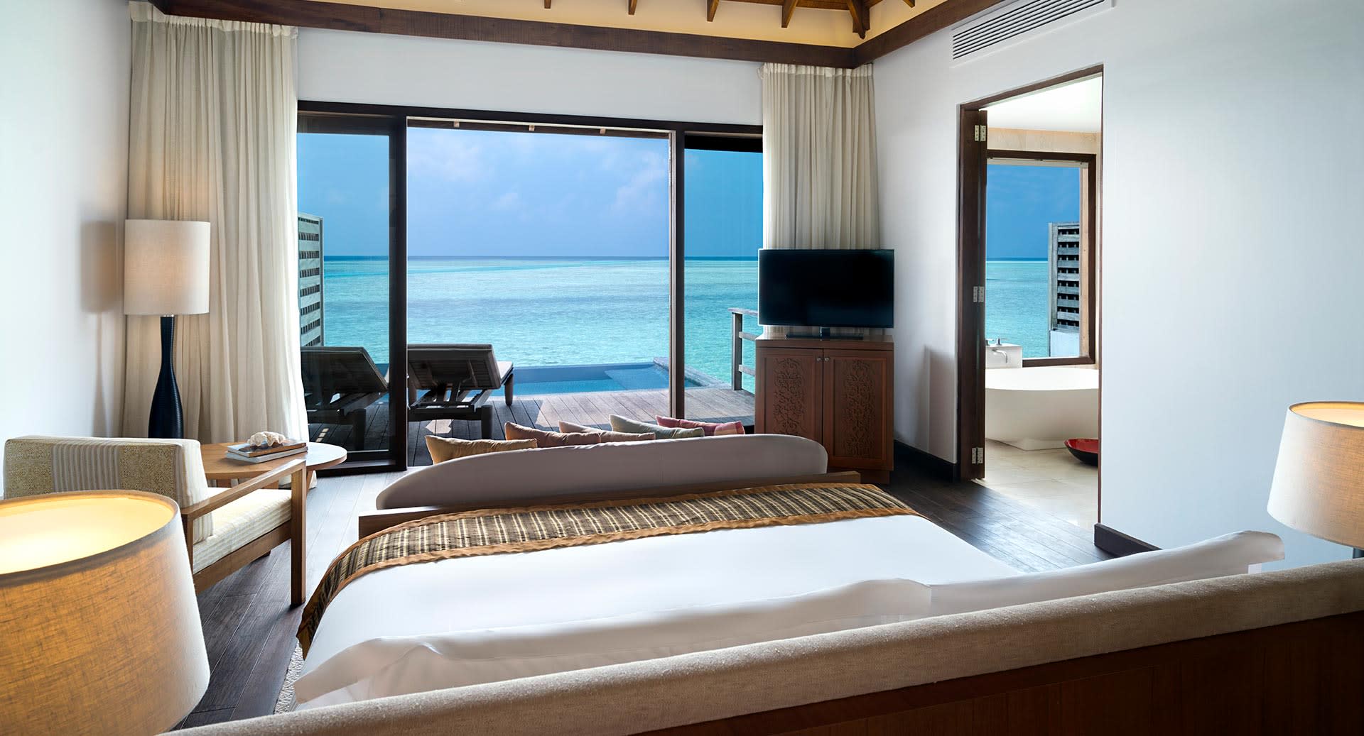 anantara_veli_maldives_deluxe_over_water_pool_bungalow_bedroom_01_1920x1037.jpg