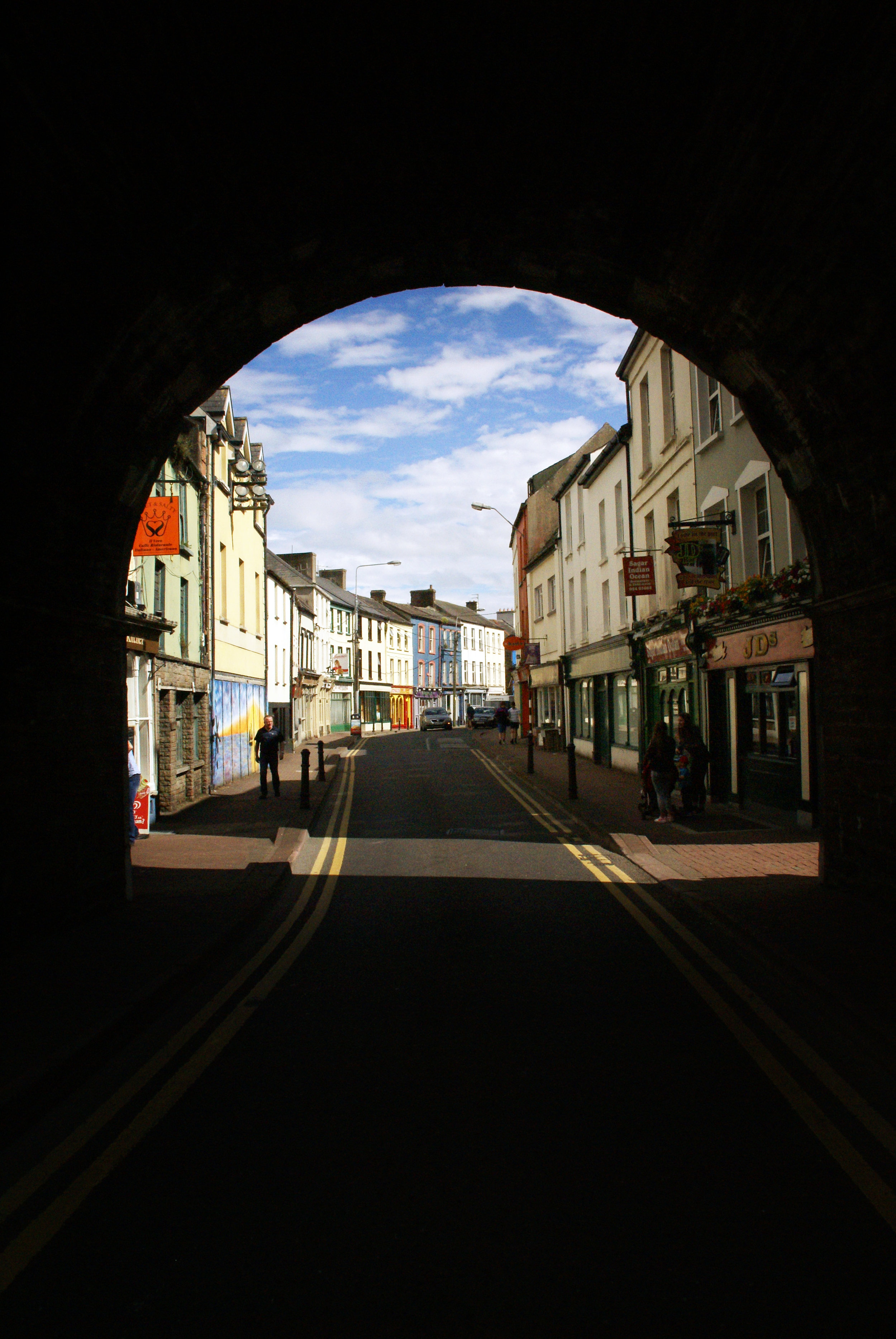 We stopped in a quaint seaside town called Youghal. It was a quick stop so I tried to get as many photos as I could before hopping back on the bus. I stumbled upon this picturesque tunnel that framed all the colorful buildings and blue sky on the ot