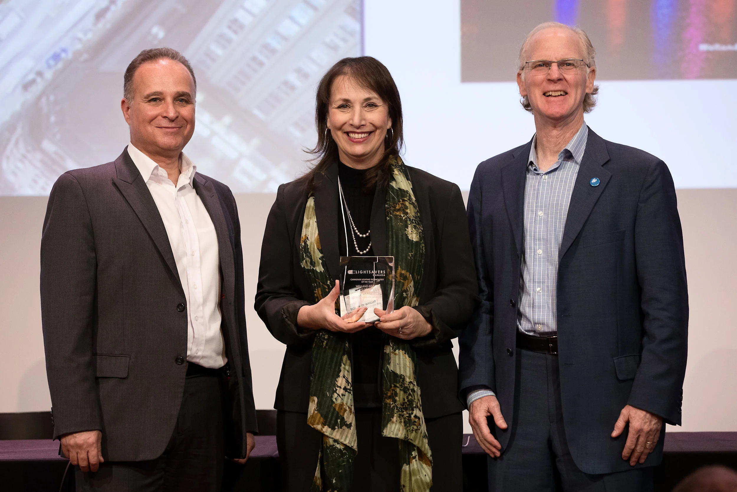 Dolorese Wright accepting the award on behalf of Welland Downtown BIA with Peter Halsall and Angelo Miceli.