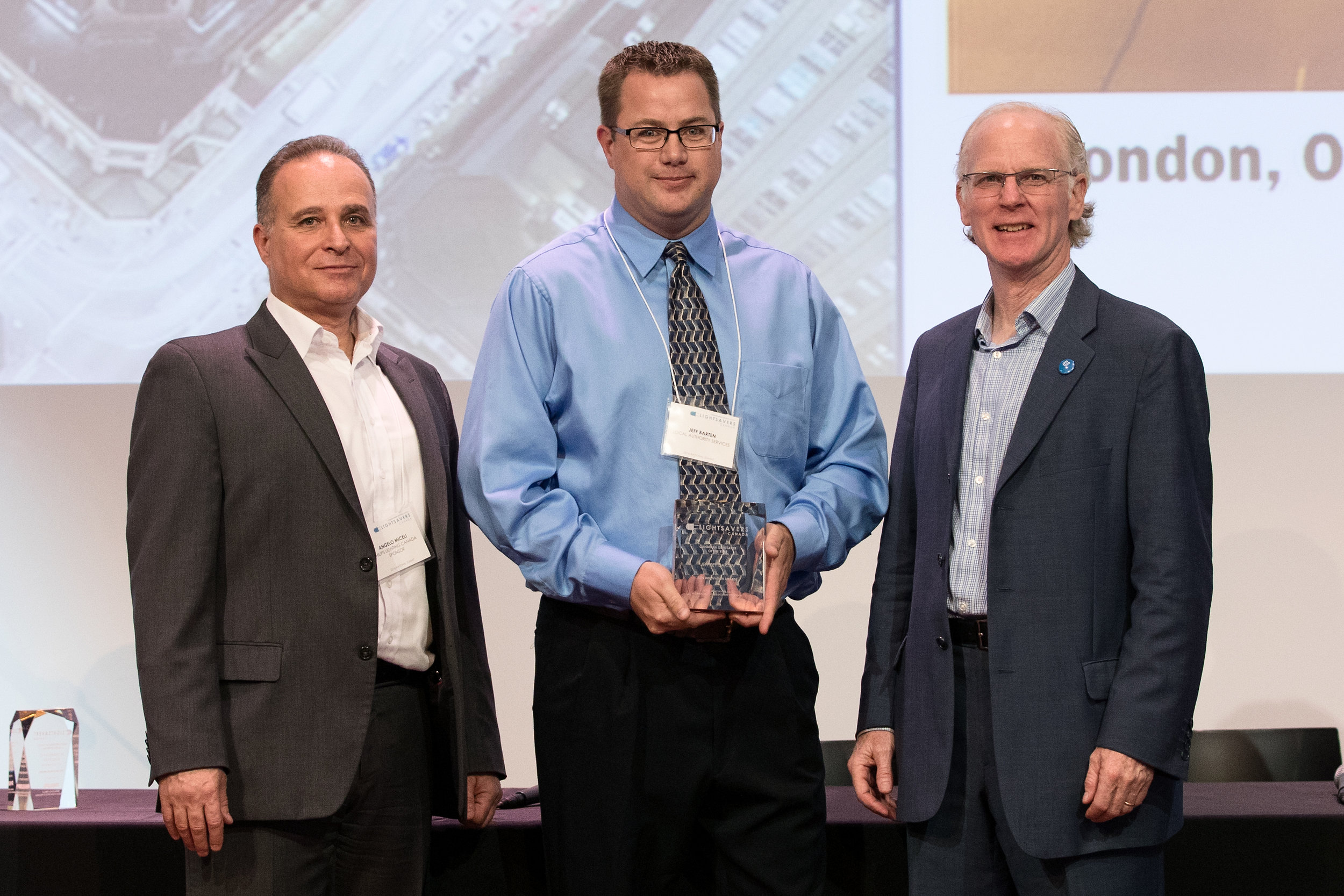 Jeffrey Barten accepting the award with Peter Halsall and Angelo Miceli.