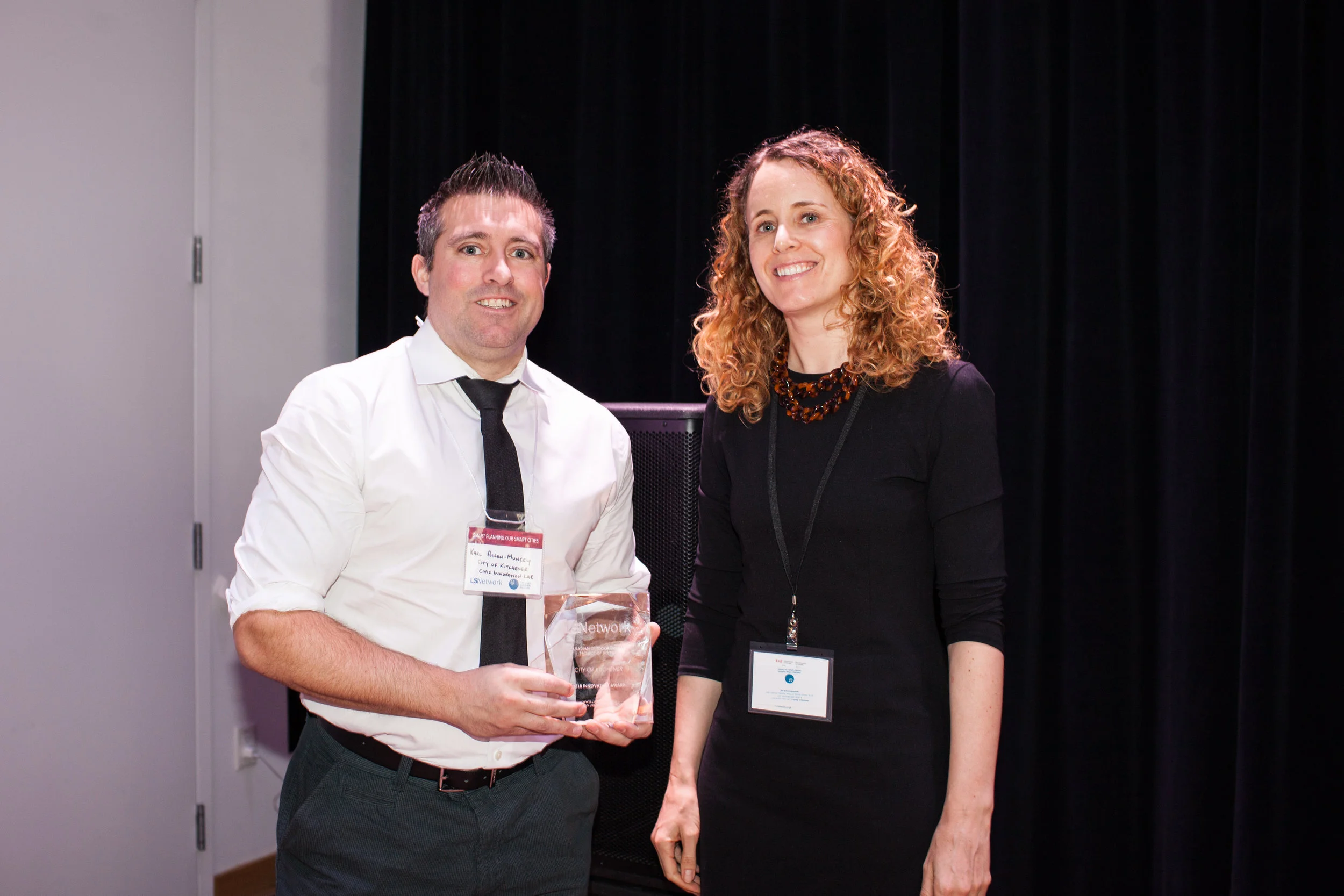 Karl Allen-Muncey accepting the award on behalf of the City of Kitchener with Amanda Smith, Director of LSNetwork.