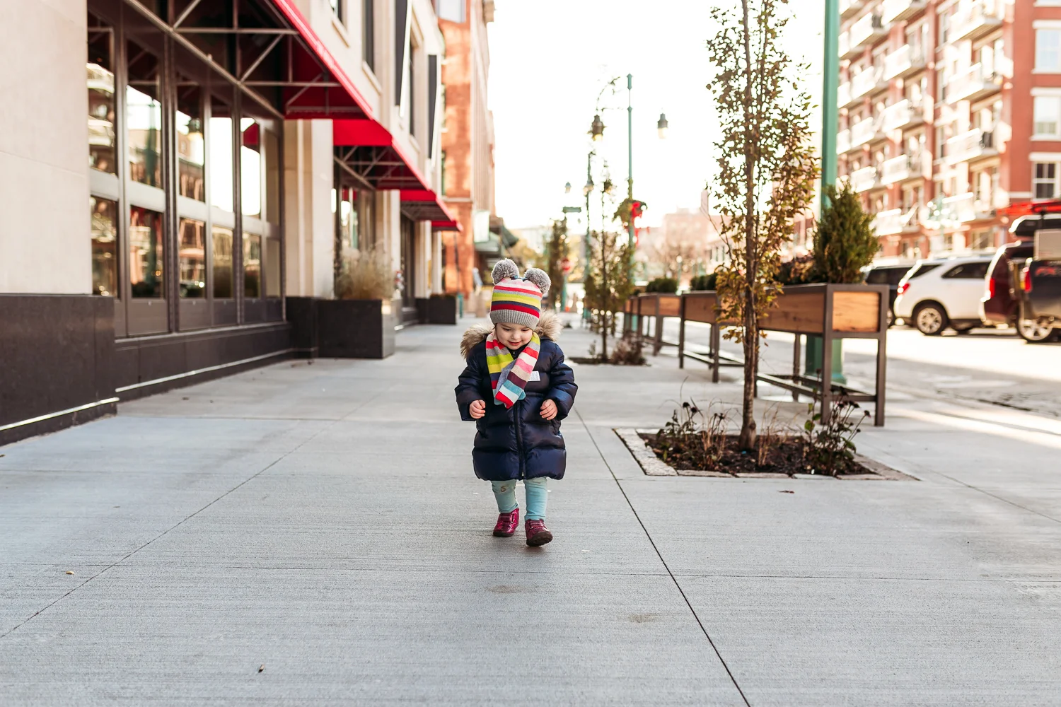 Little girl walking in Milwaukee's third ward.