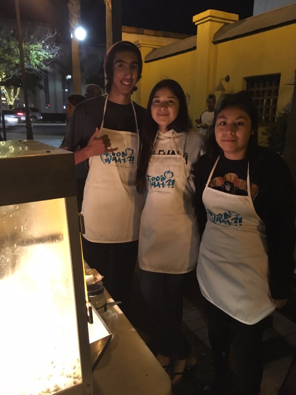 Ozzy, Natasha, and Eustolia -- part of the Food and Catering Crew -- making complimentary FoodWhat grown popcorn to distribute to families at the opening night of the Watsonville Film Festival downtown!