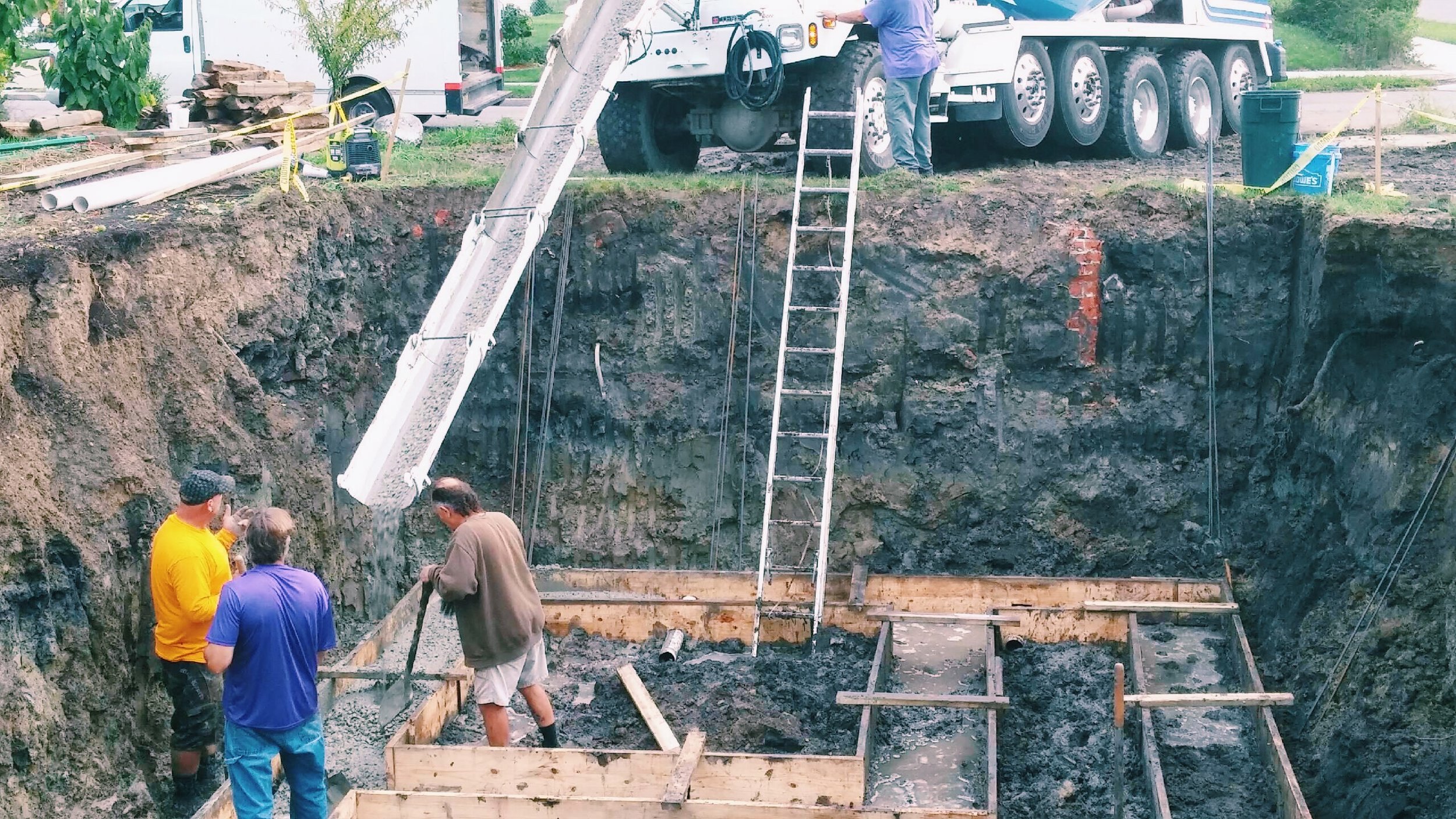 Here we are having a delivery of cement to make the footings. The hole was 40' long, 20' wide and 9' deep. You can not see it here, but we have a 10" deep 10' x 4' cavity in the floor that holds pea gravel and water. This inner reservoir of water is what creates the high 80-90 percent humility we need to over winter dahlia and gladiola tubers. The root cellarBeing embedded this deep in the ground ensures that the inner temperature of the root cellar will not exceed 50 degrees, perfect for dahlias.
