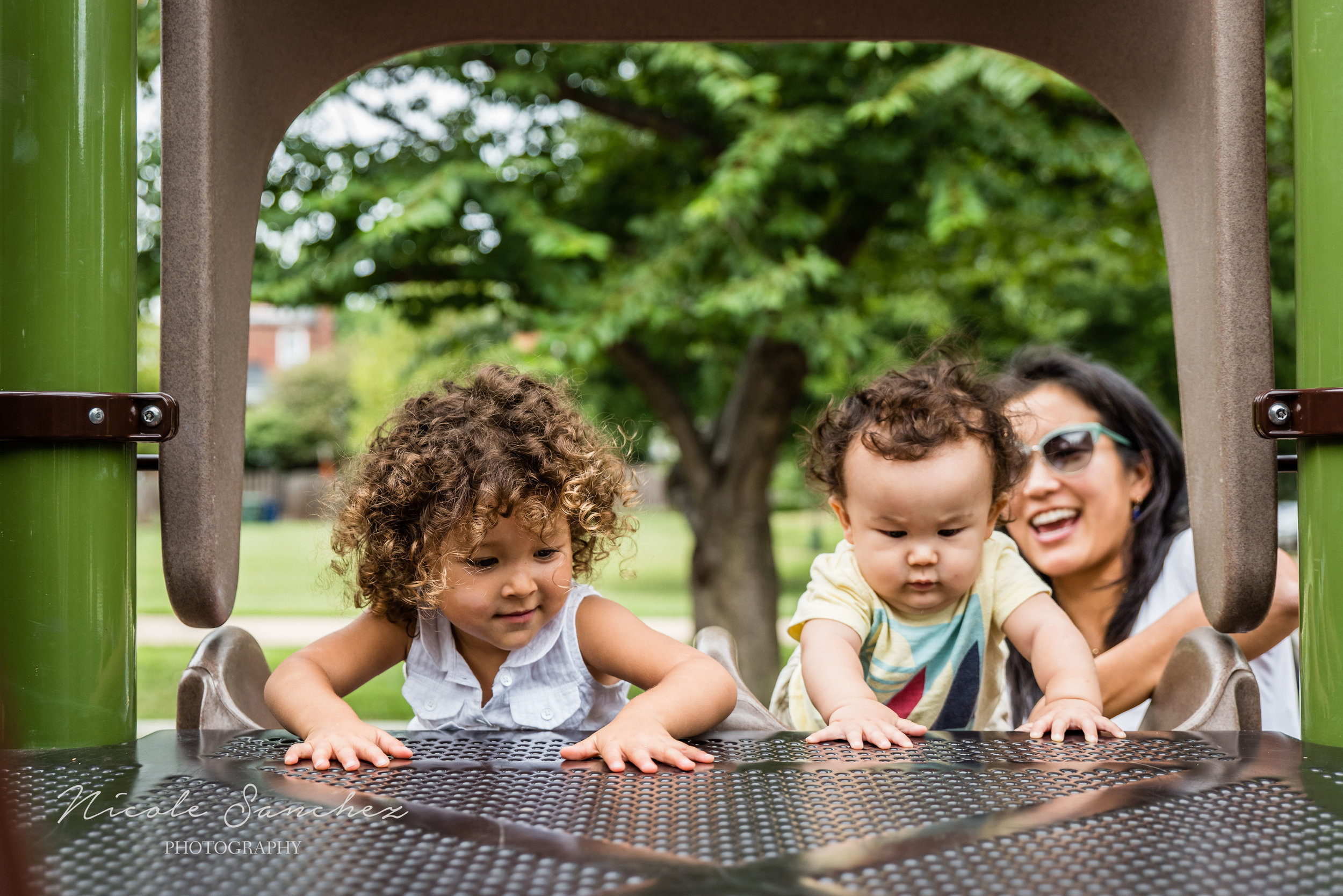 Toddler and baby climbing slide with mom | Old Town Alexandria, VA Family Photographer