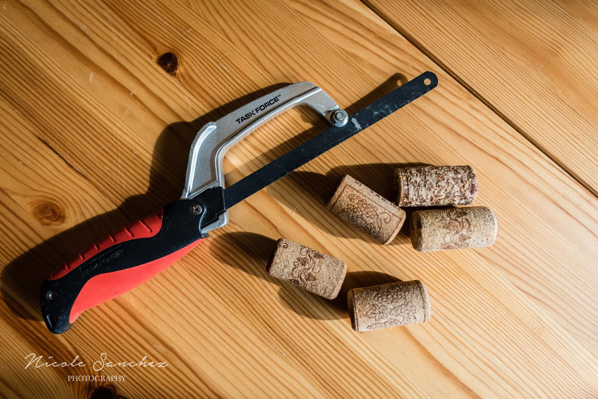 Using hand saw to cut cork by Northern Virginia Family Photographer Nicole Sanchez