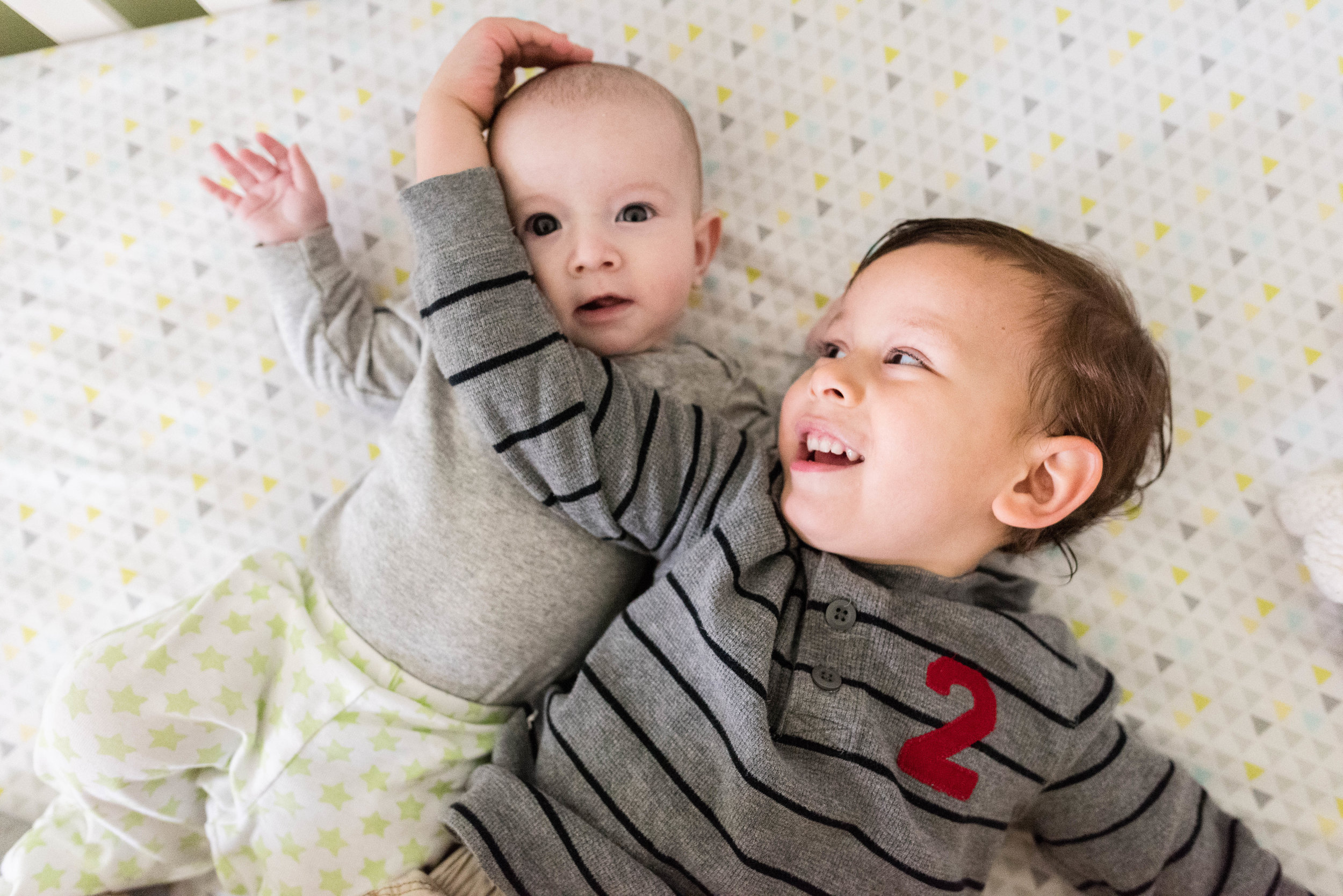 Brothers playing in crib by Northern Virginia Family Photographer Nicole Sanchez