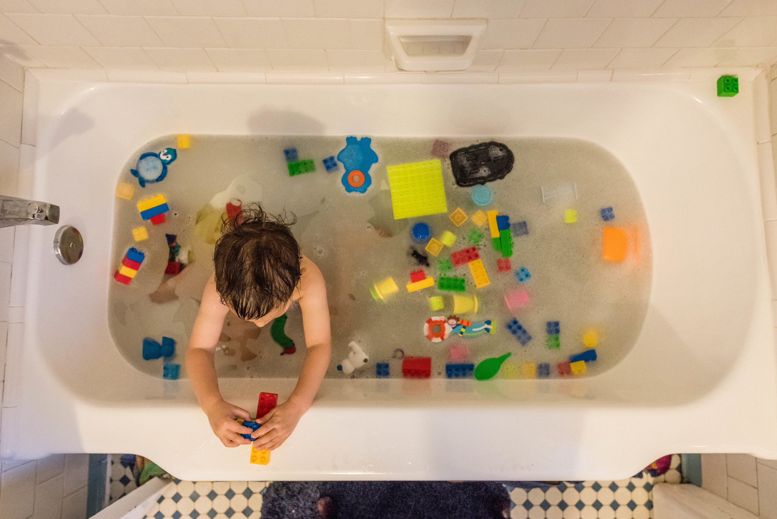 Boy playing with legos in bath by Northern Virginia Family Photographer Nicole Sanchez