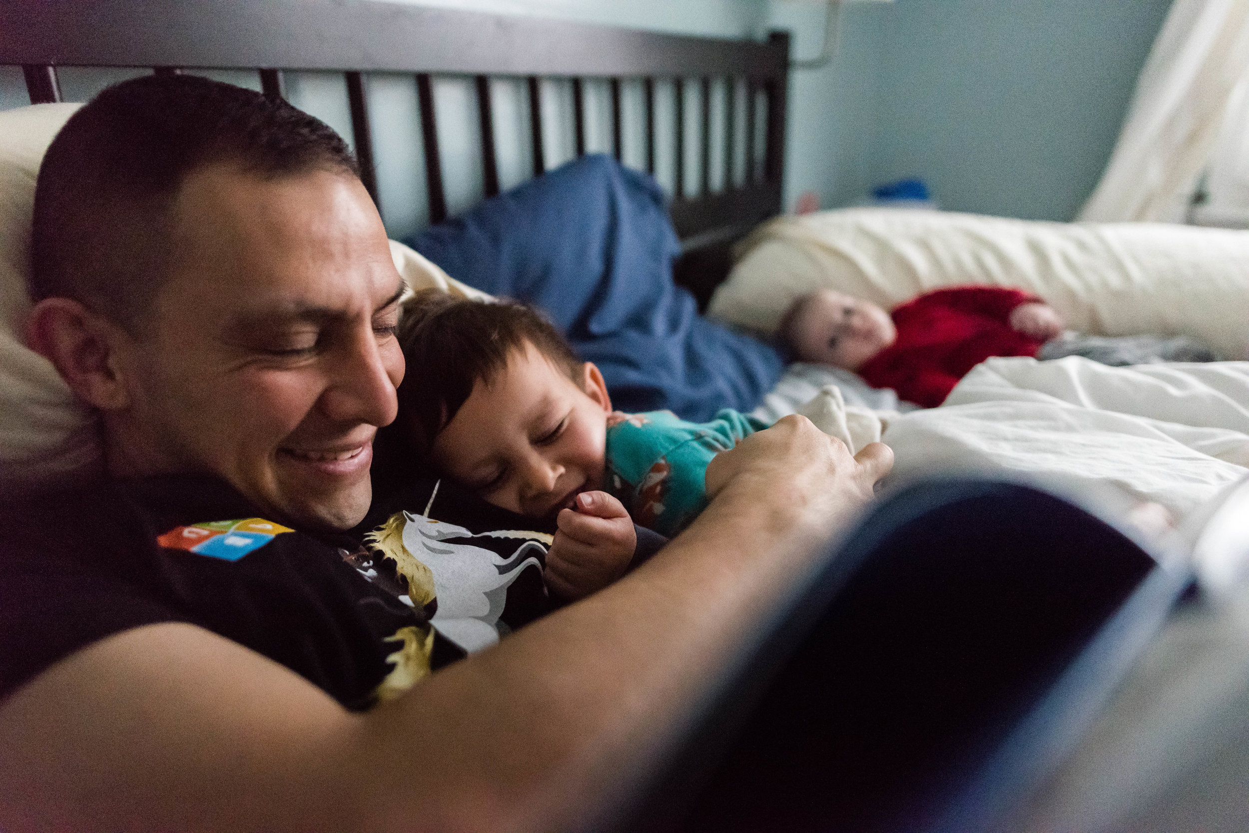 Boy cuddling with Dad by Alexandria, Virginia Family Photographer Nicole Sanchez