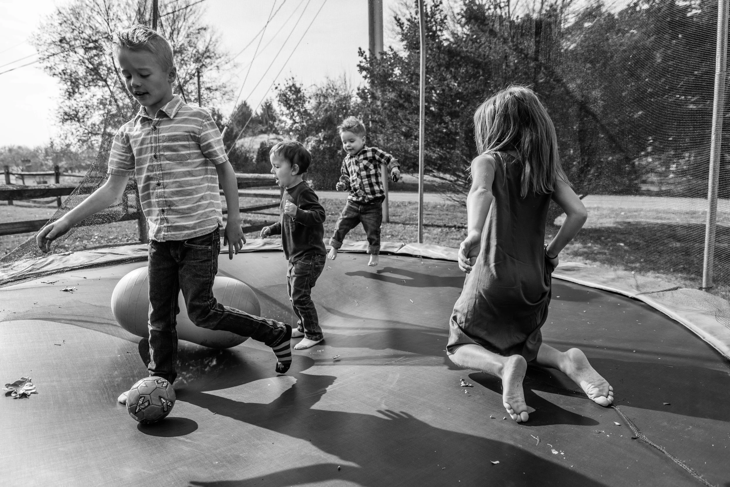 Kids playing on trampoline by Northern Virginia Family Photographer
