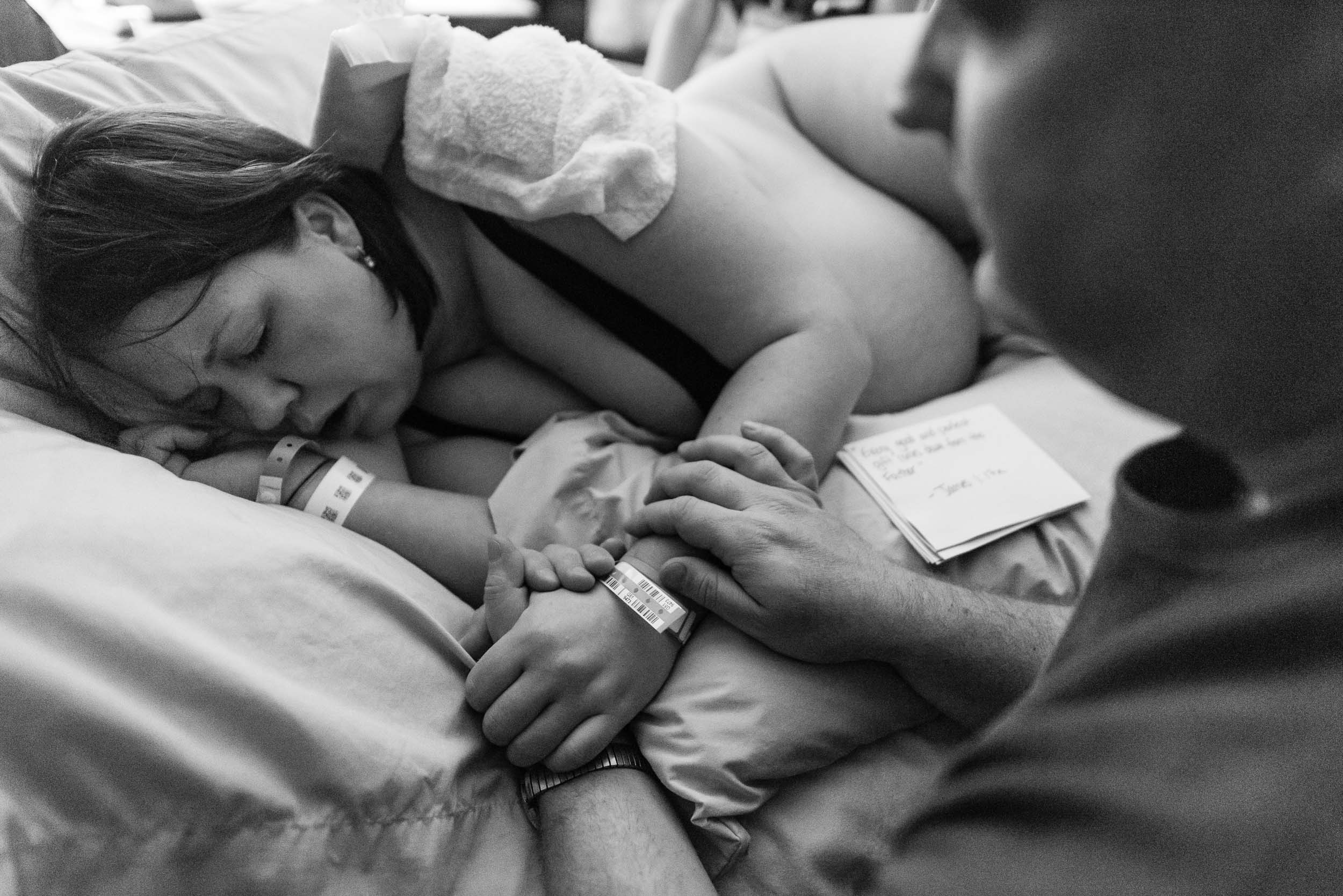 Husband comforting wife in labor at Northern Virginia hospital by Family Photographer Nicole Sanchez