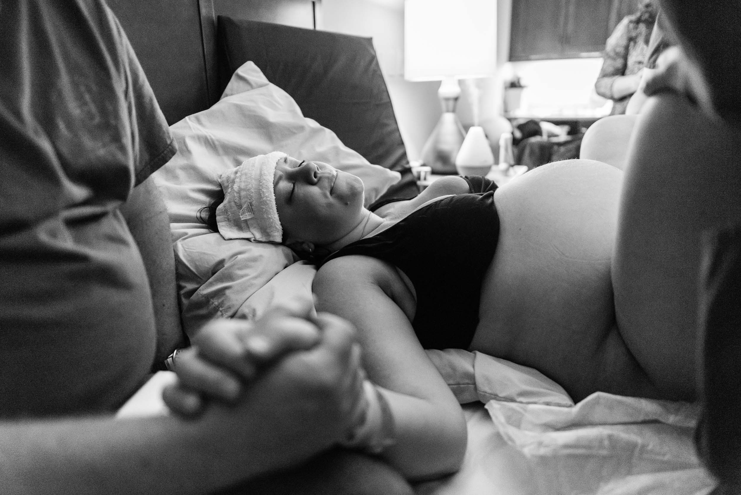 Woman giving birth in Northern Virginia hospital by Family Photographer Nicole Sanchez
