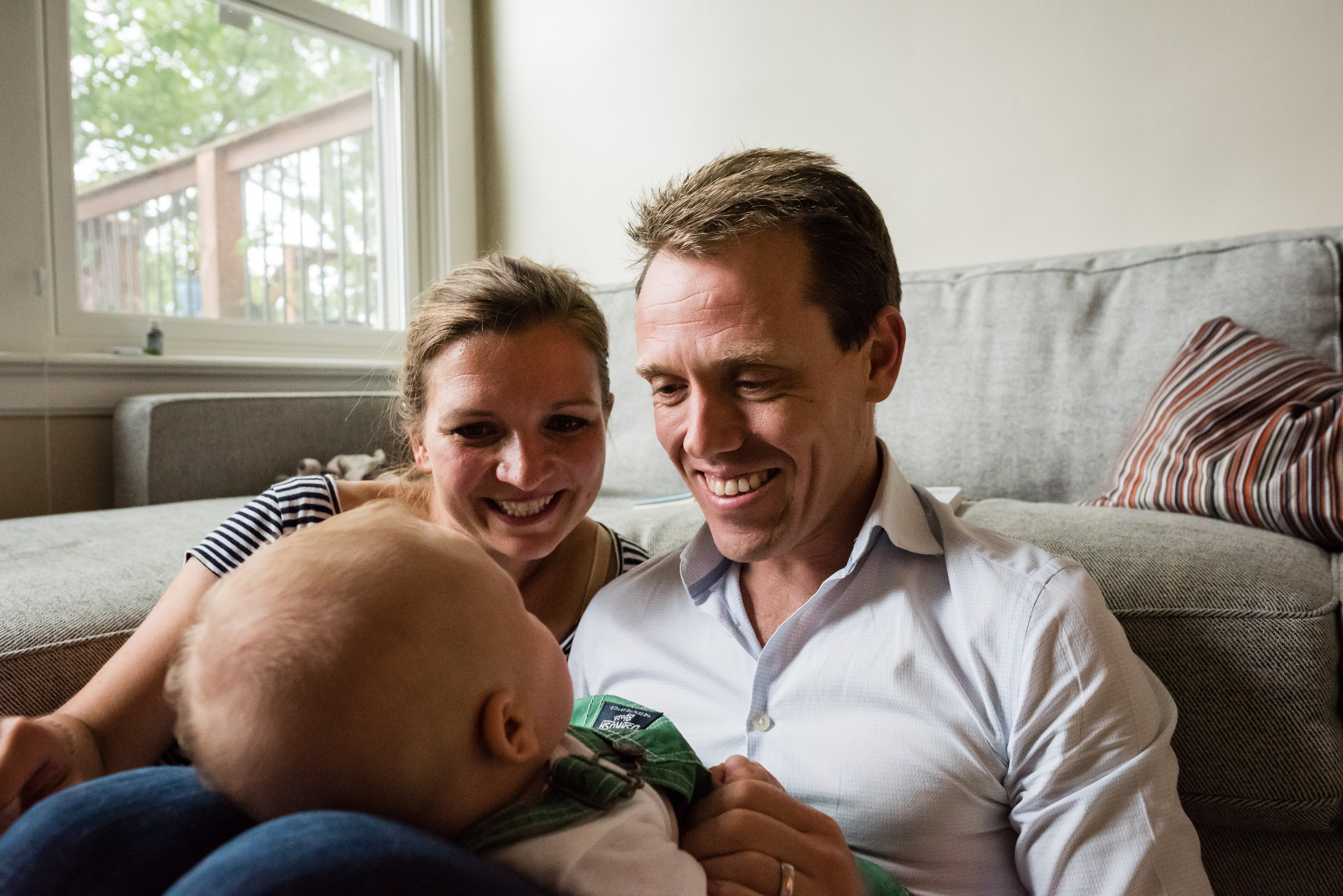 Parents smiling at baby in Washington, DC by Lifestyle Family Photographer Nicole Sanchez