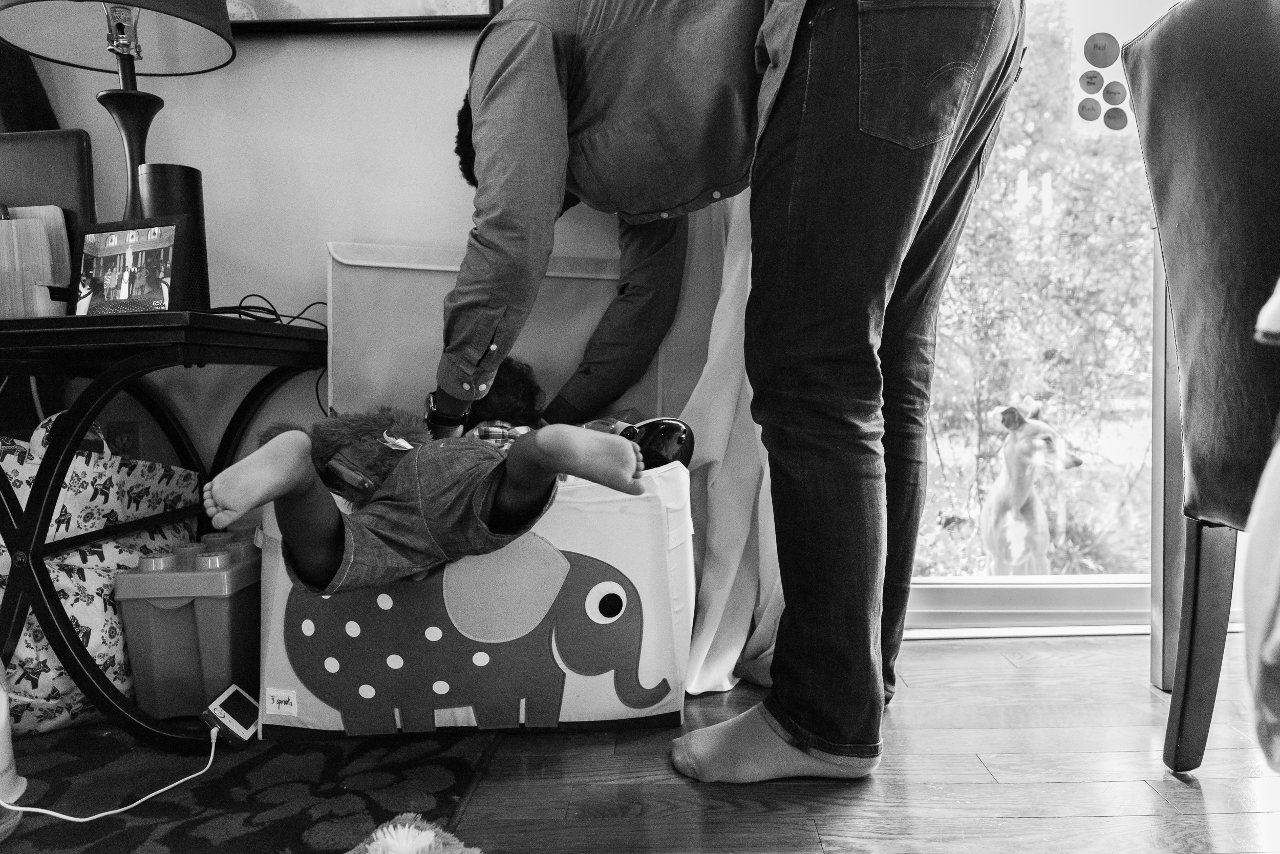 Dad helping son look for toys in bin by Northern Virginia Family Photographer Nicole Sanchez