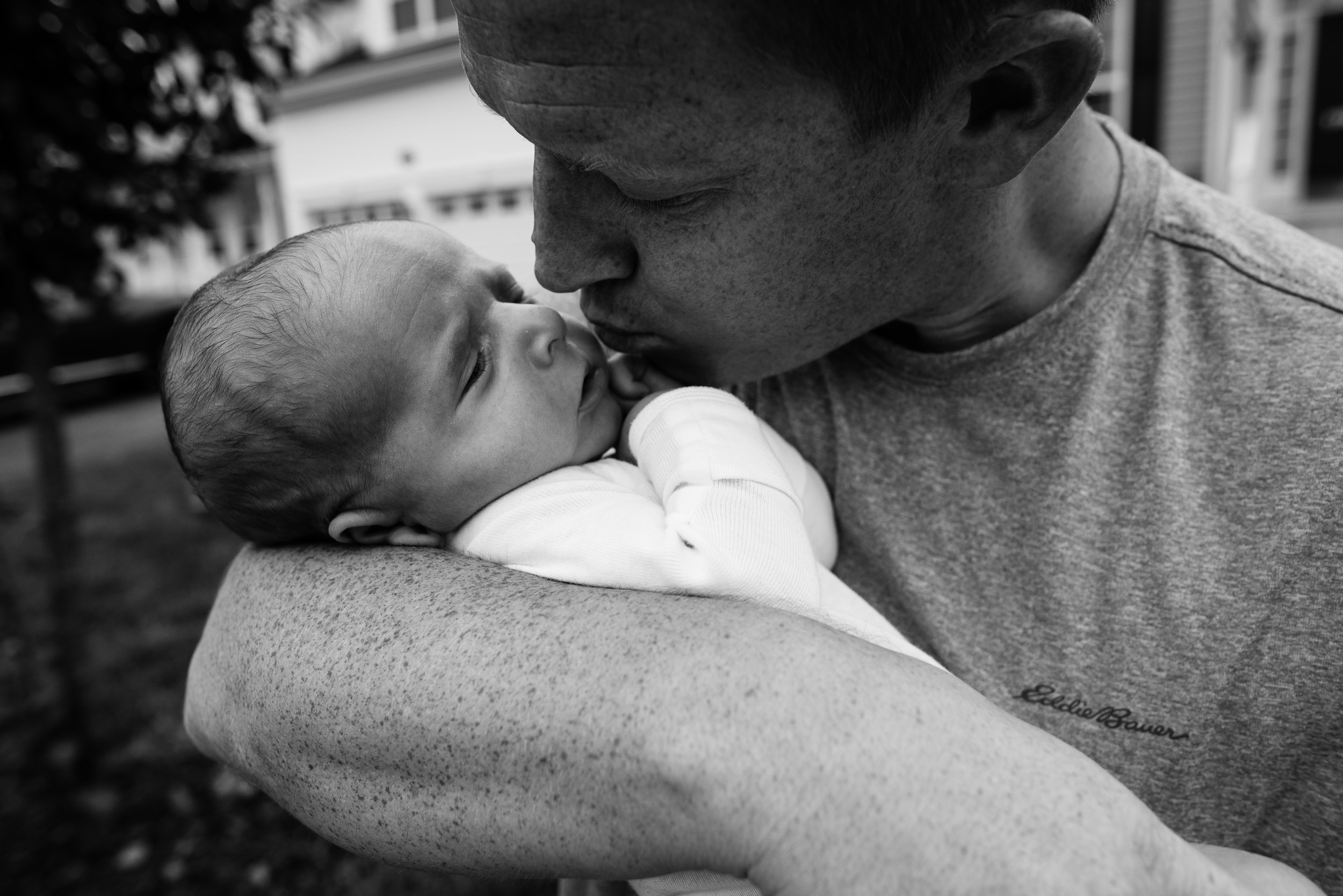 Dad kissing newborn son by Northern Virginia Family Photographer Nicole Sanchez