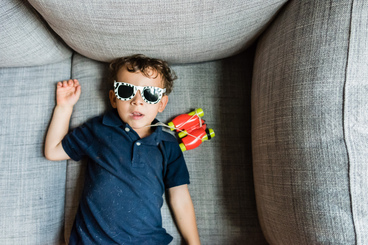 boy wearing sunglasses indoors by northern virginia family photographer nicole sanchez