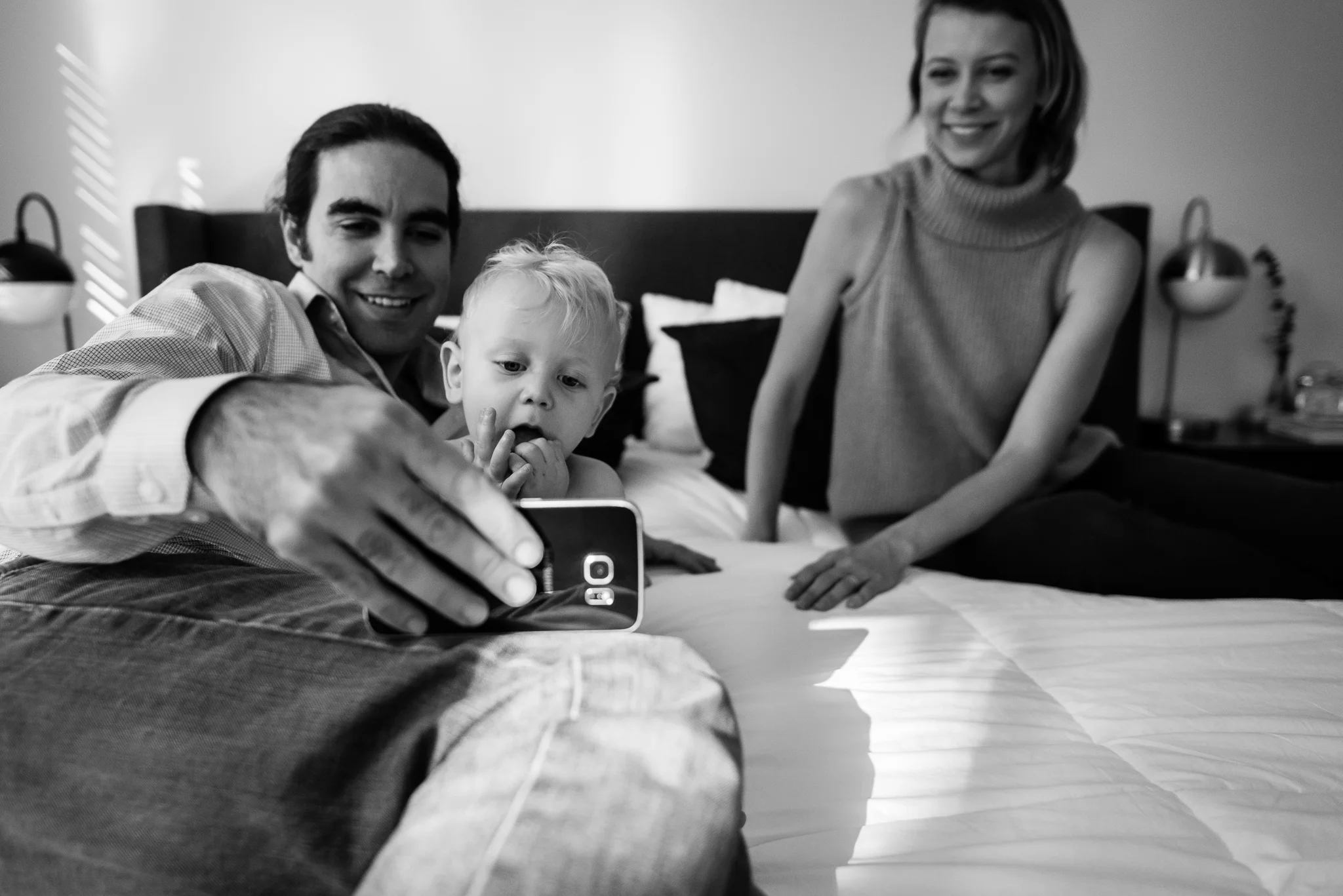 Parents playing with baby and smart phone by Washington, DC Family Photographer Nicole Sanchez