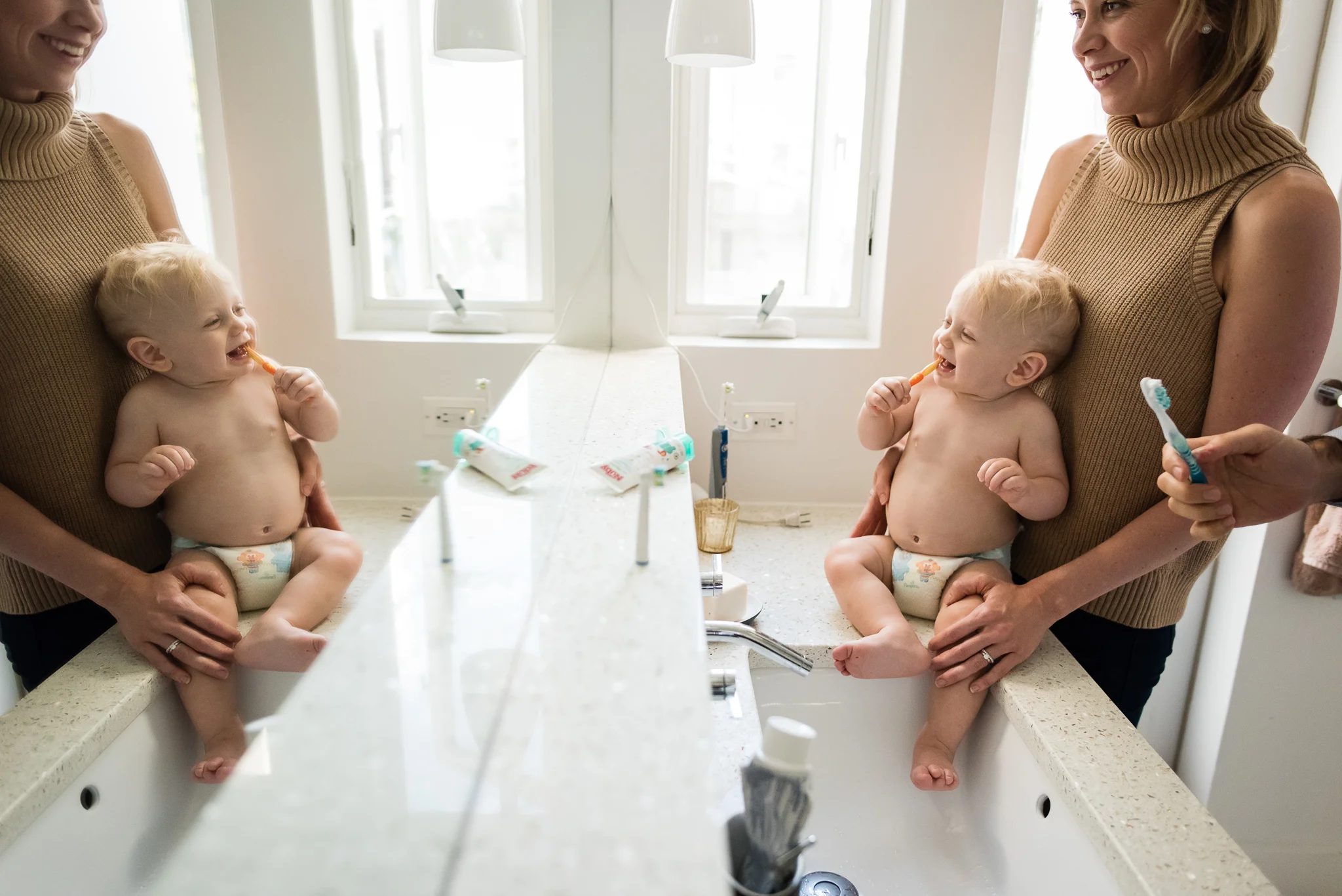 Baby brushing teeth with mom and dad by Washington, DC Family Photographer Nicole Sanchez