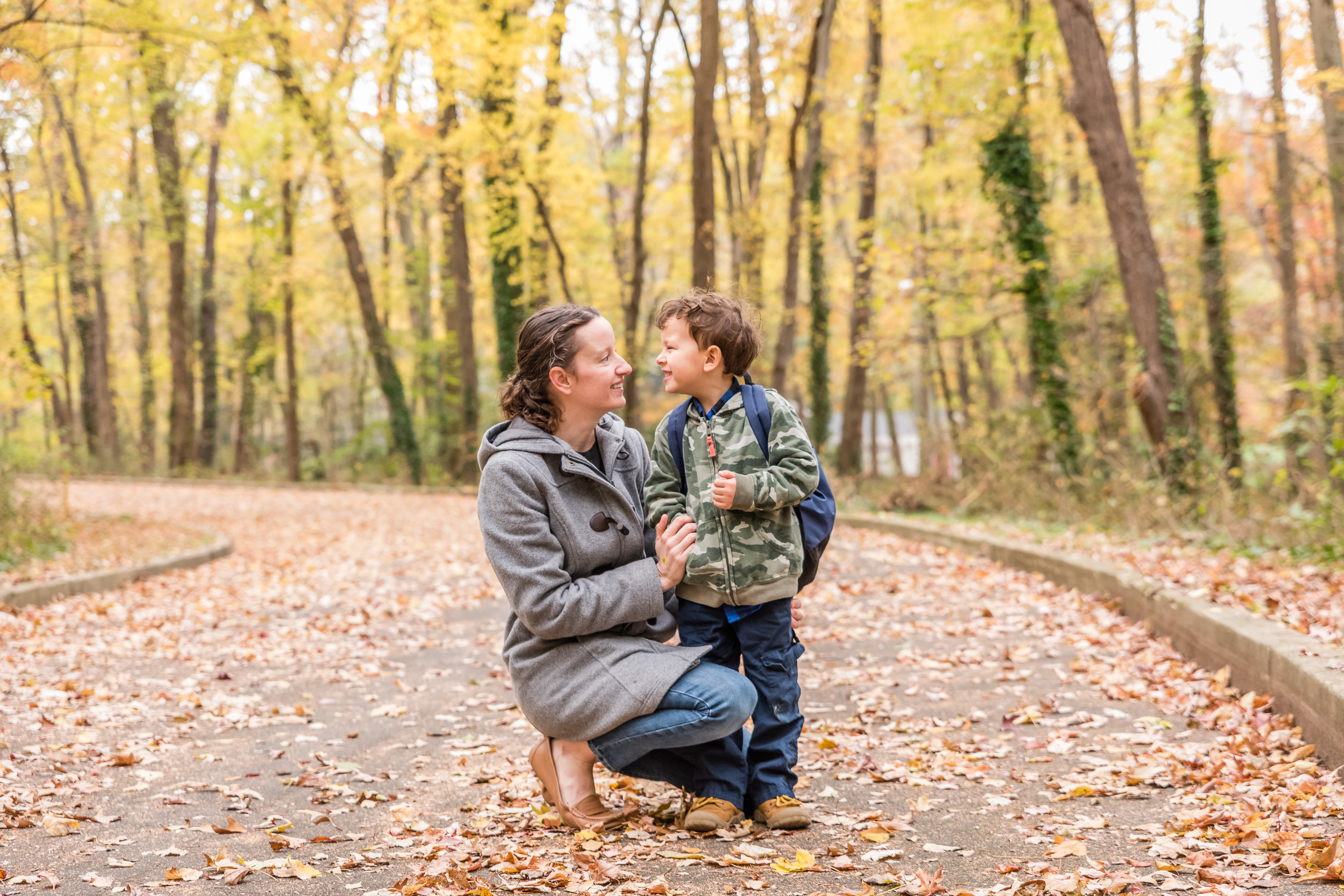 Mom and son with autumn leaves by Northern Virginia Family Photographer Nicole Sanchez