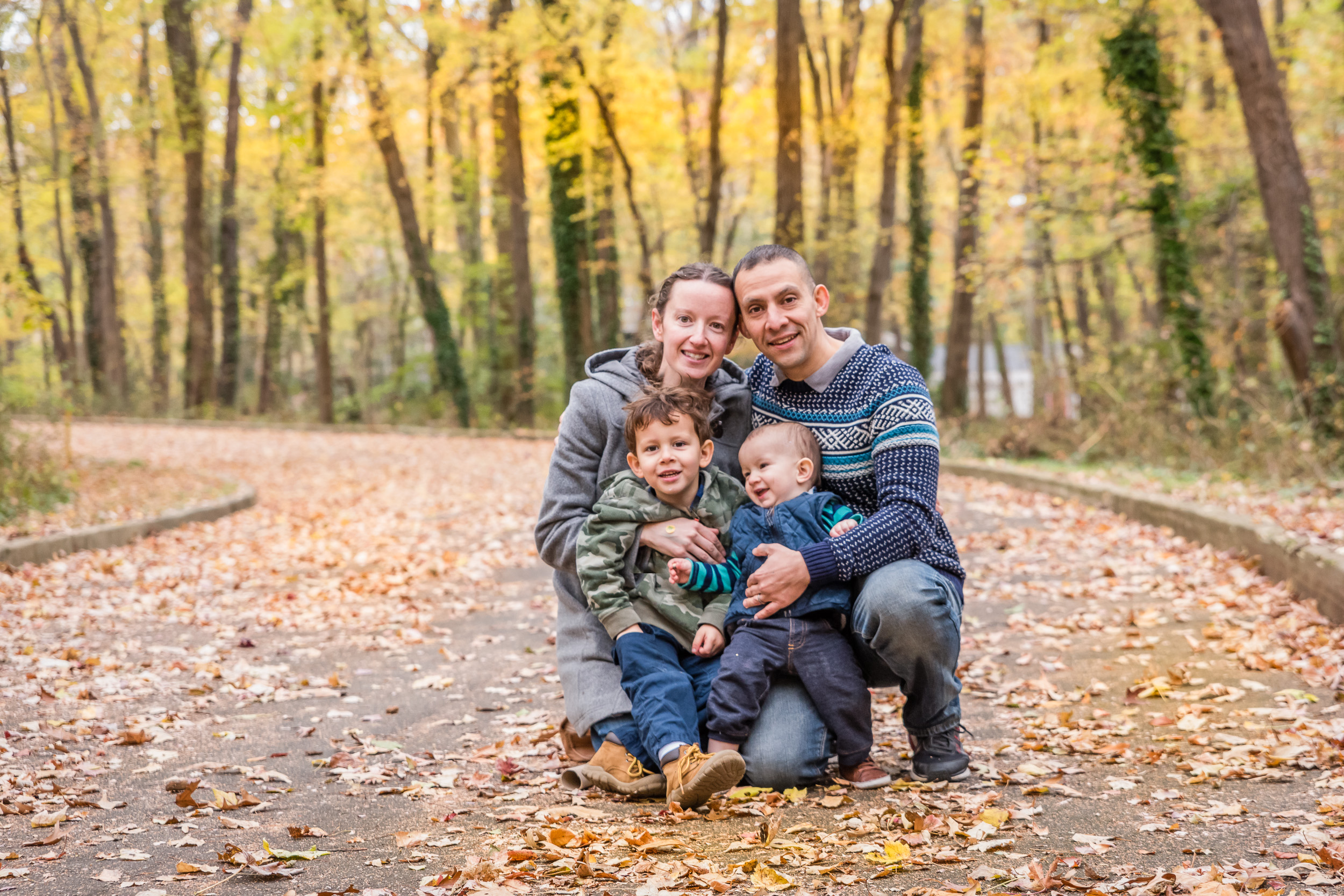 Family portrait in autumn leaves by Northern Virginia Family Photographer Nicole Sanchez