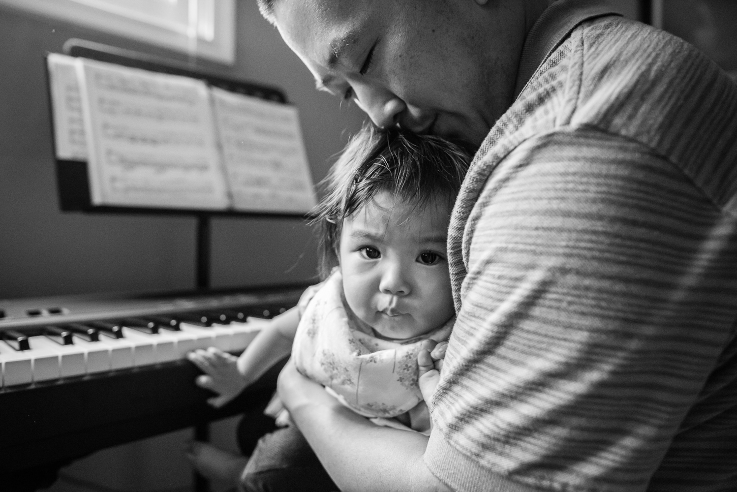 Dad kissing top of daughter's head