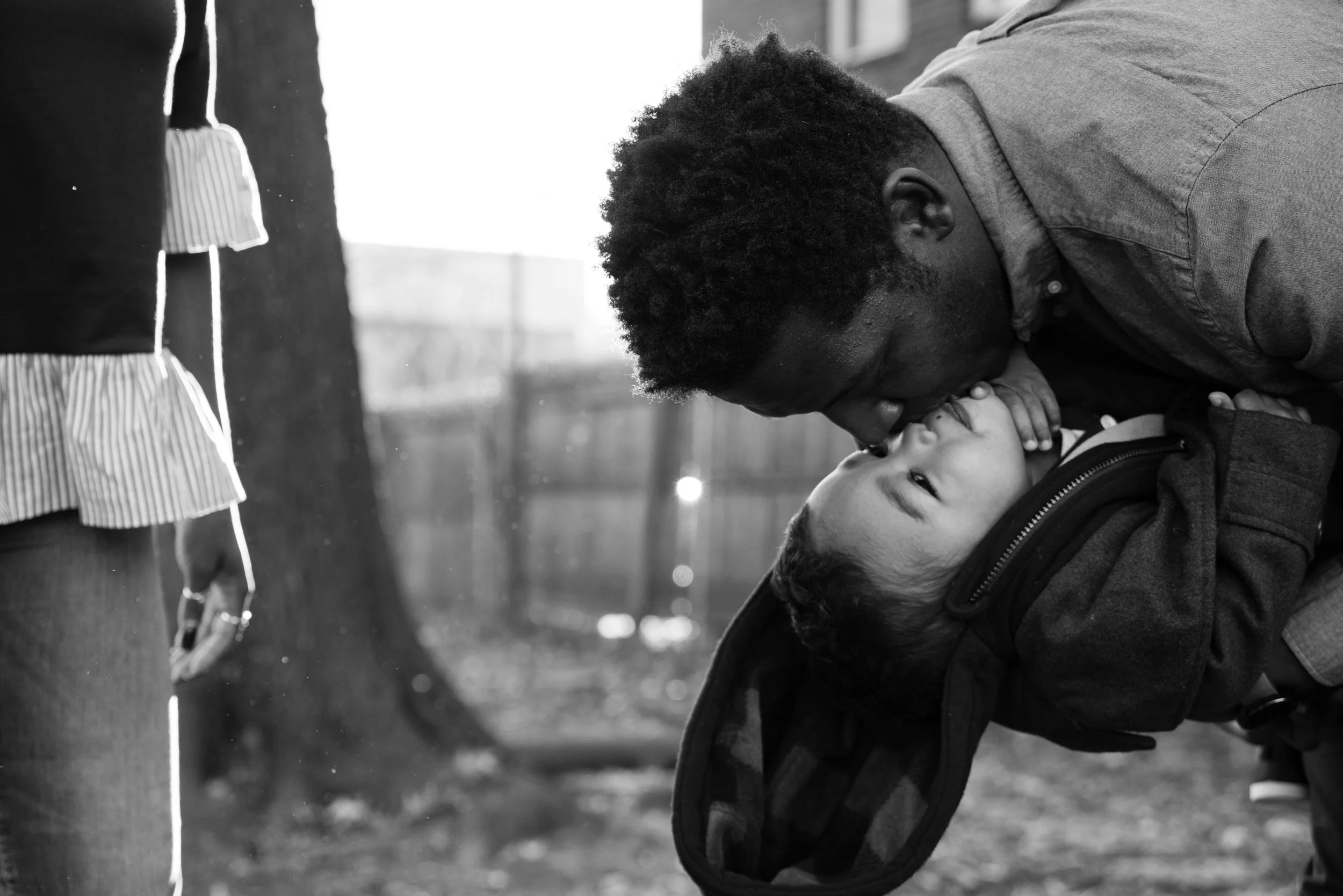 Dad playfully kissing son