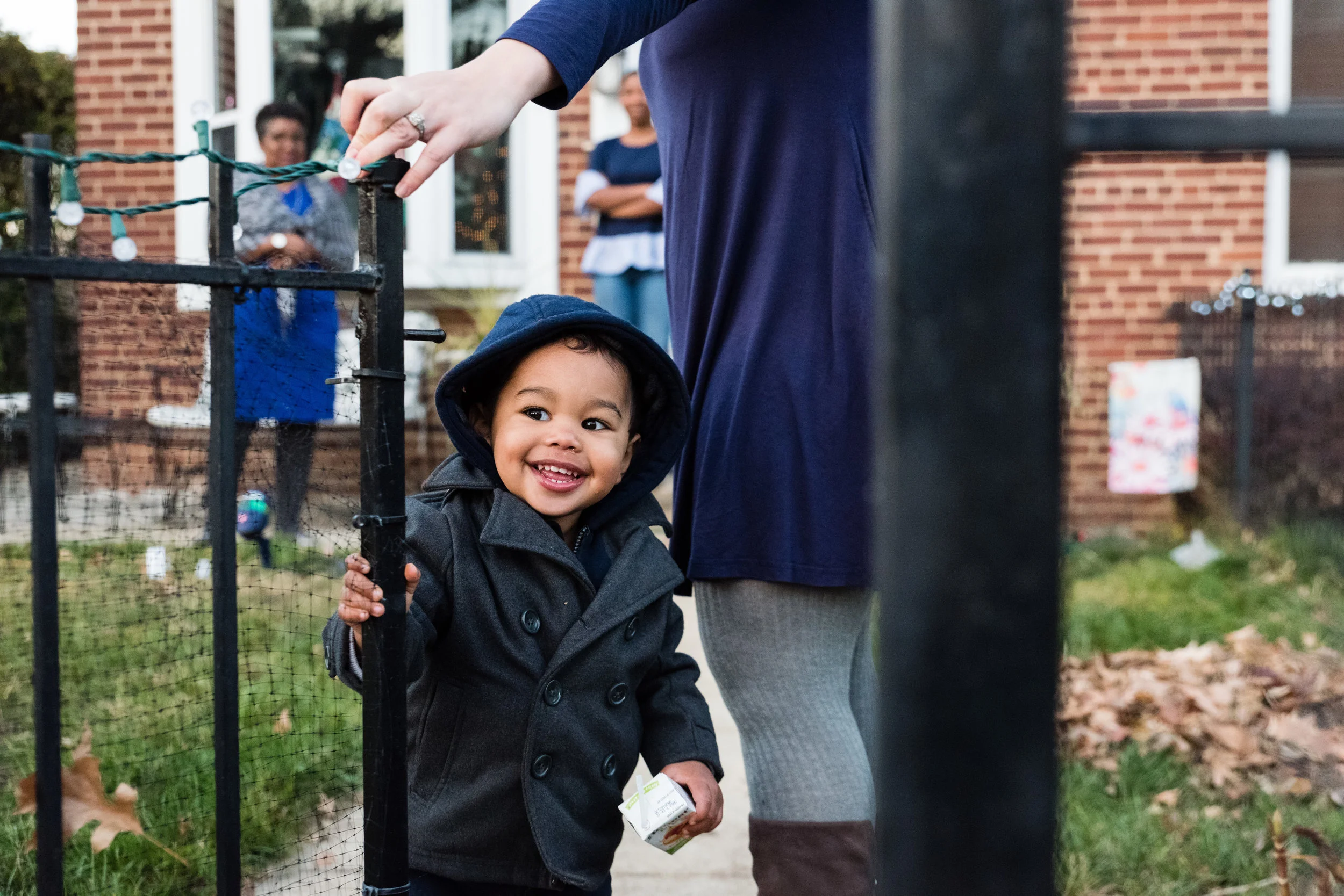 Toddler saying goodbye and closing gate