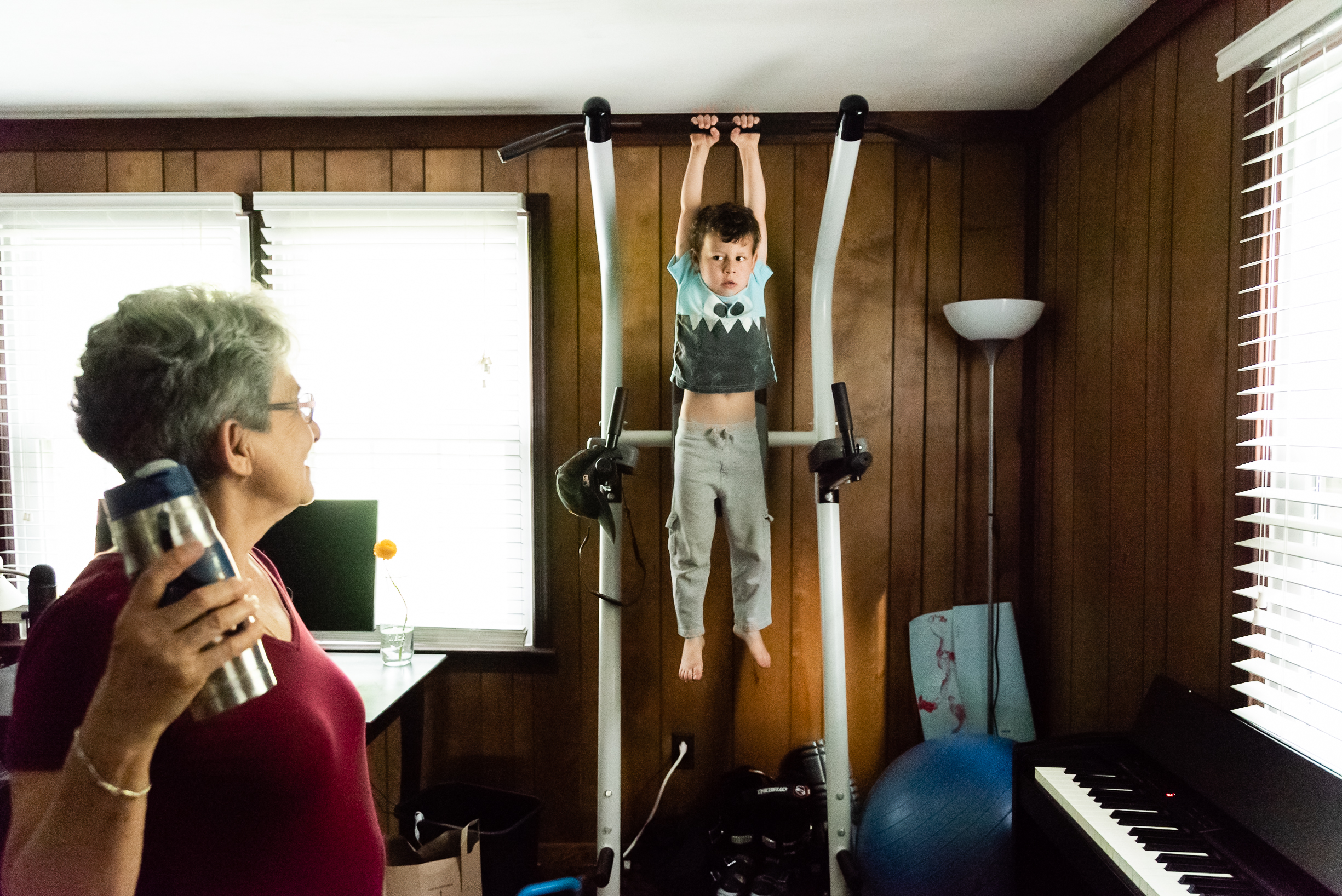 Boy hanging from pull-up bar by Northern Virginia Family Photographer Nicole Sanchez