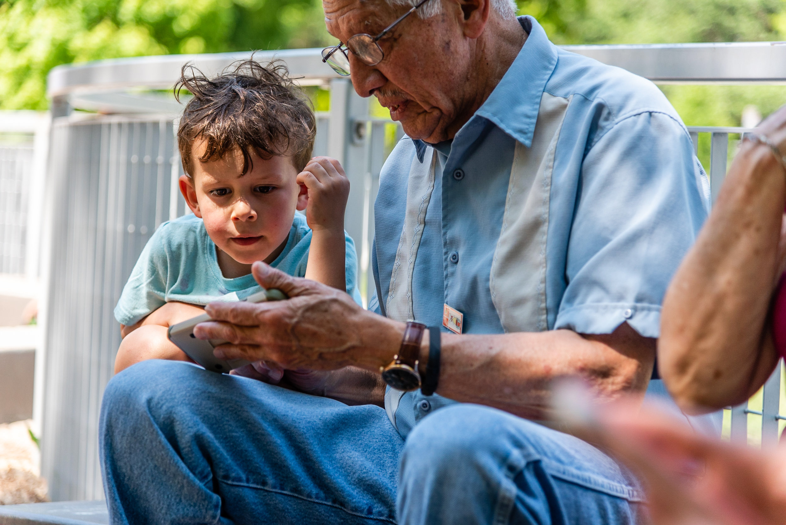 Grandfather and grandson with cell phone by Northern Virginia Family Photographer Nicole Sanchez