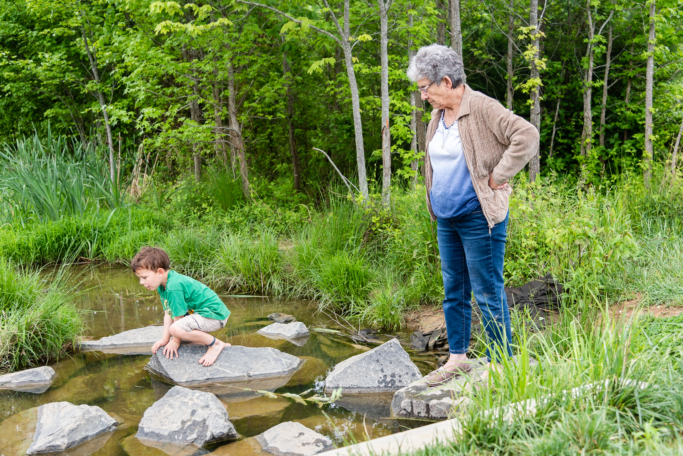 Grandmother and grandson exploring creek by Northern Virginia Family Photographer Nicole Sanchez