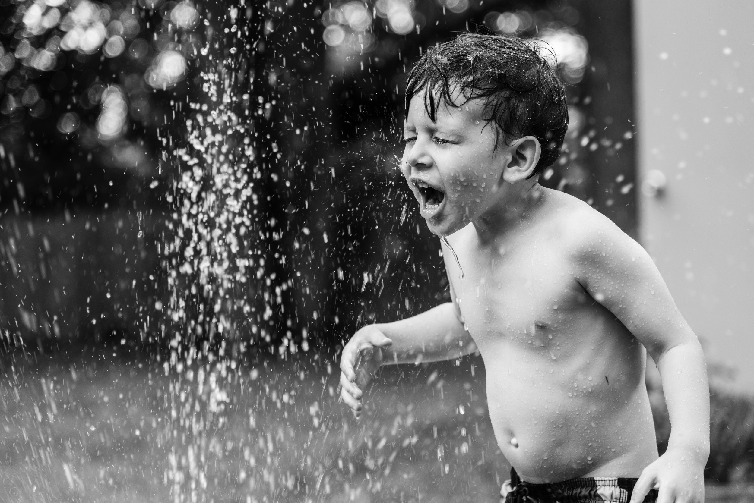 Boy playing in sprinkler by Northern Virginia Family Photographer Nicole Sanchez