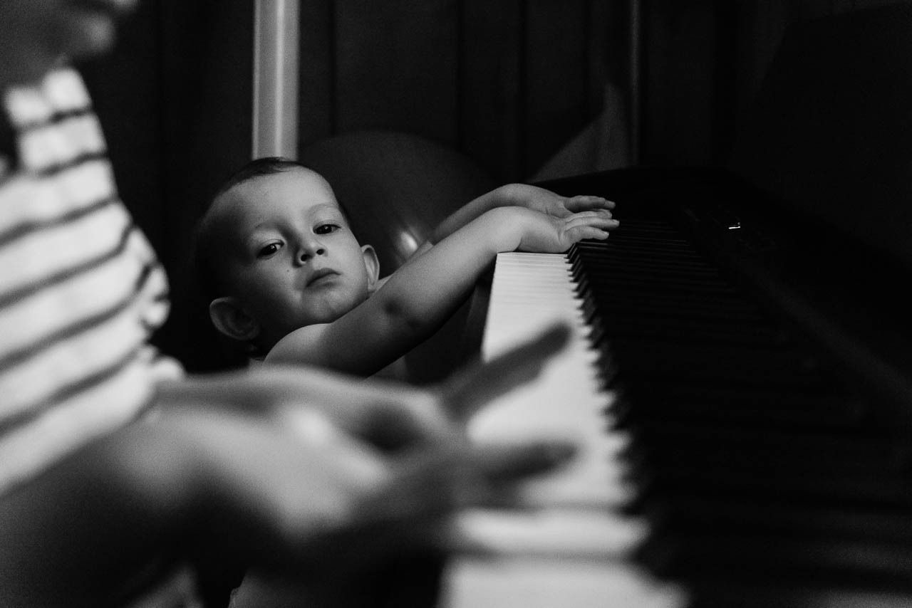Toddler watching big brother play piano by Northern Virginia Family Photographer Nicole Sanchez