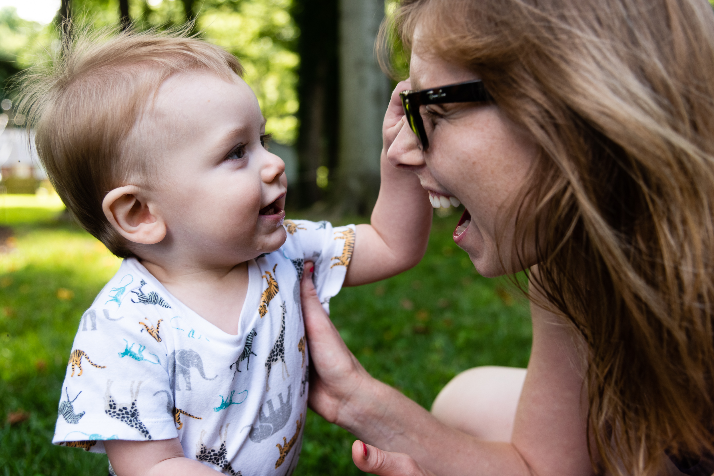 toddler playing with mom's sunglasses in the backyard by northern virginia family photographer nicole sanchez