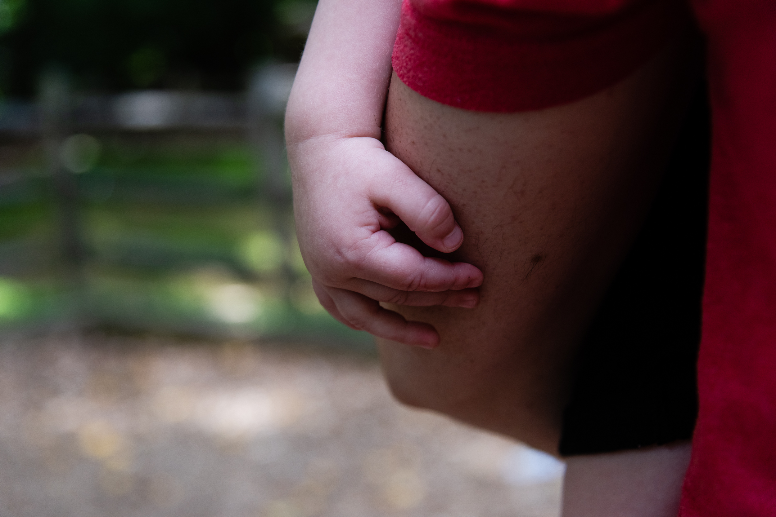 Toddler son holding on to dad at park in northern virginia by family photographer nicole sanchez