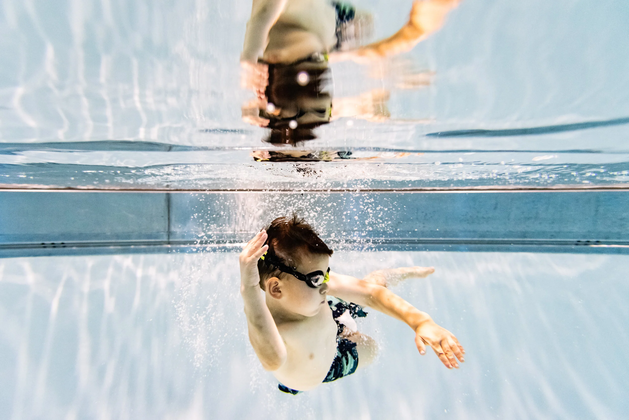 Boy in swimming pool by Northern Virginia Family Photographer Nicole Sanchez