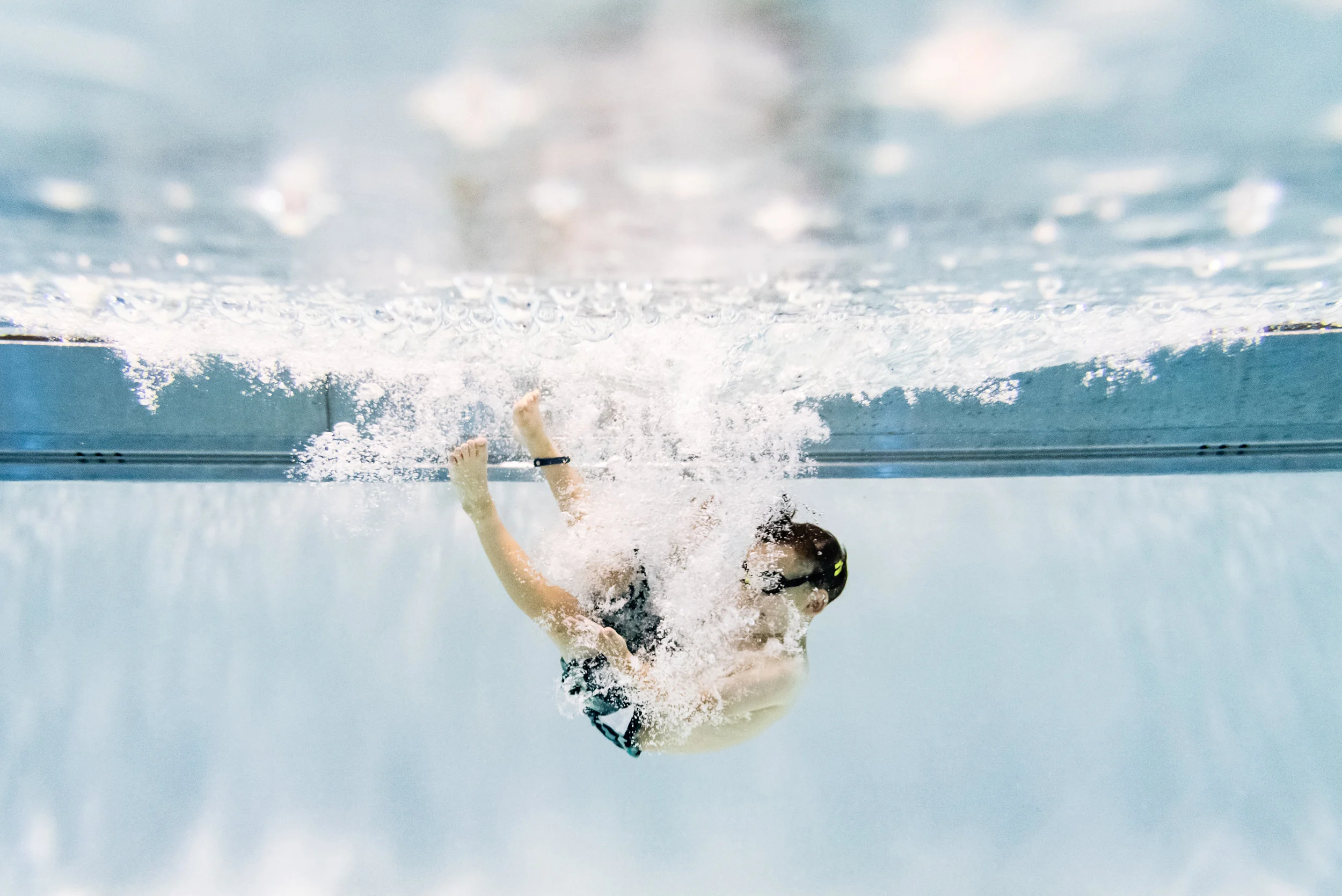 Boy jumping into pool by Northern Virginia Family Photographer Nicole Sanchez