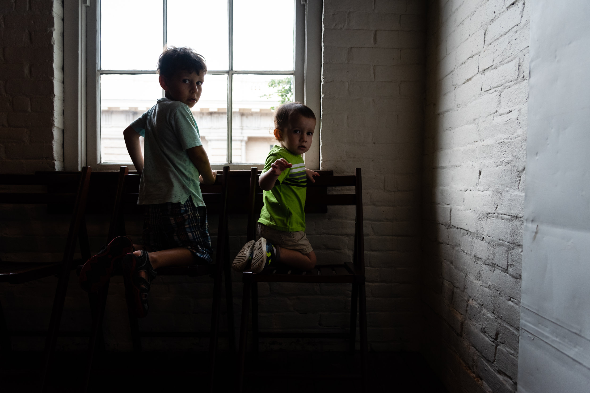 Boys looking out window at Stabler-Leadbeater Apothecary Museum by Northern Virginia Family Photographer Nicole Sanchez