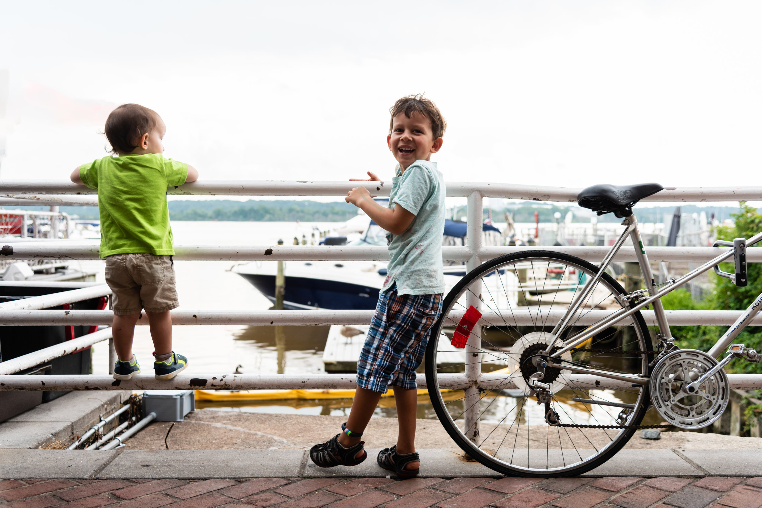 Brothers looking at Old Town Alexandria Marina by Northern Virginia Family Photographer Nicole Sanchez