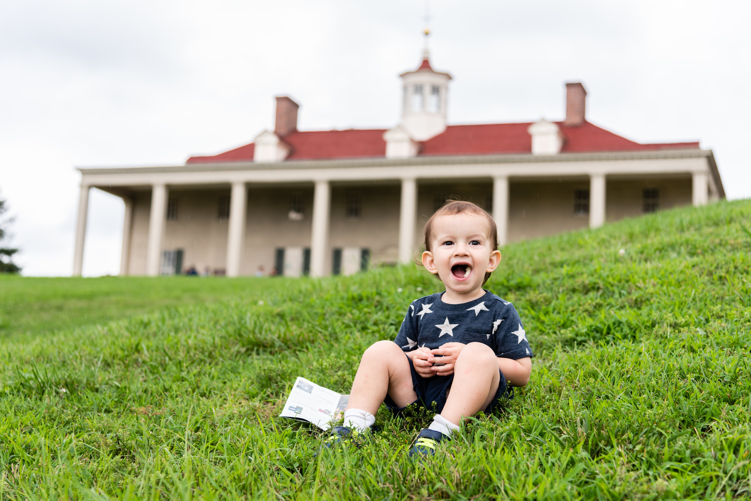 Toddler resting in front of Mount Vernon Estate in Alexandria by Northern Virginia Family Photographer Nicole Sanchez