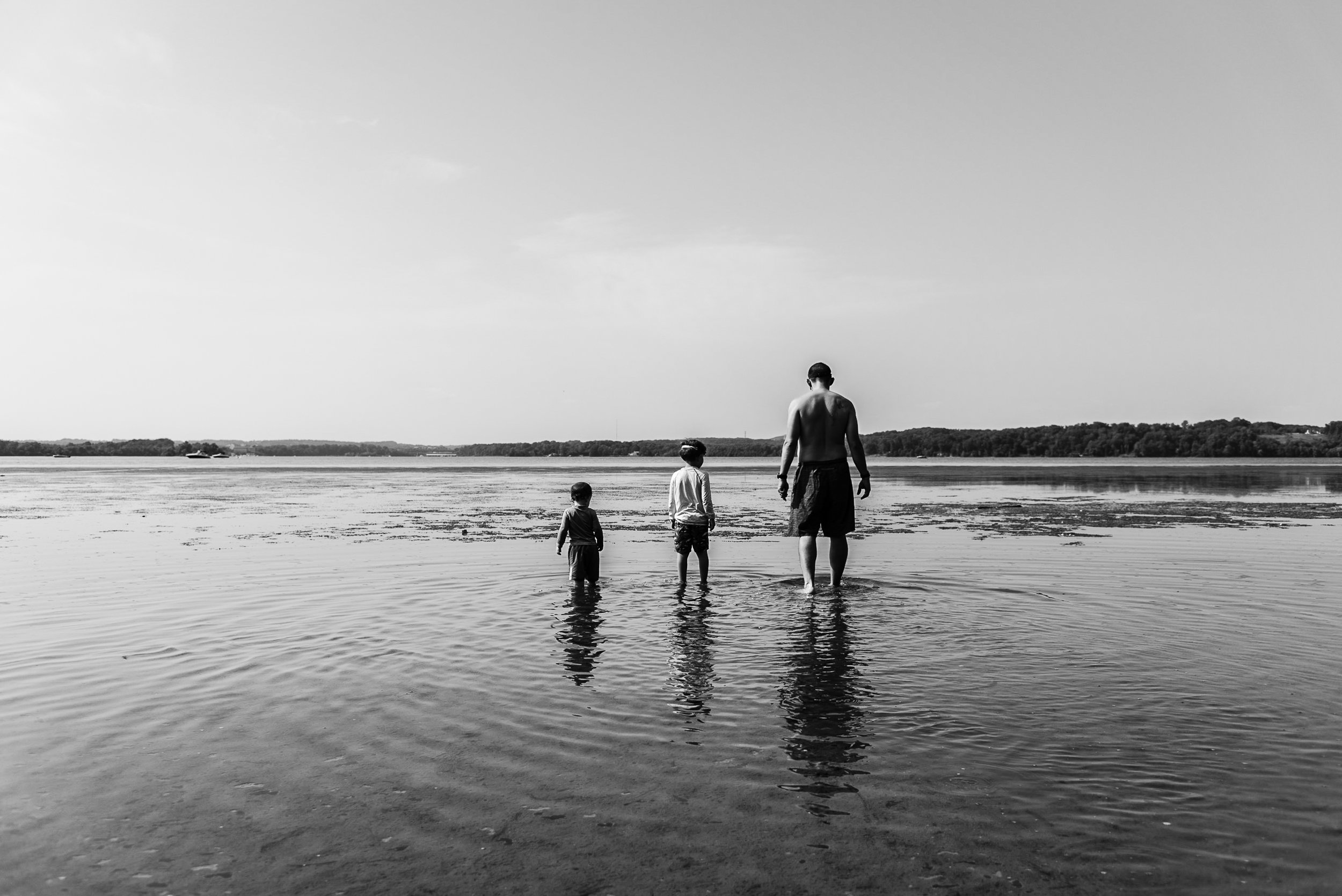 Father and sons wading in river at Mason Neck State Park by Northern Virginia Family Photographer Nicole Sanchez