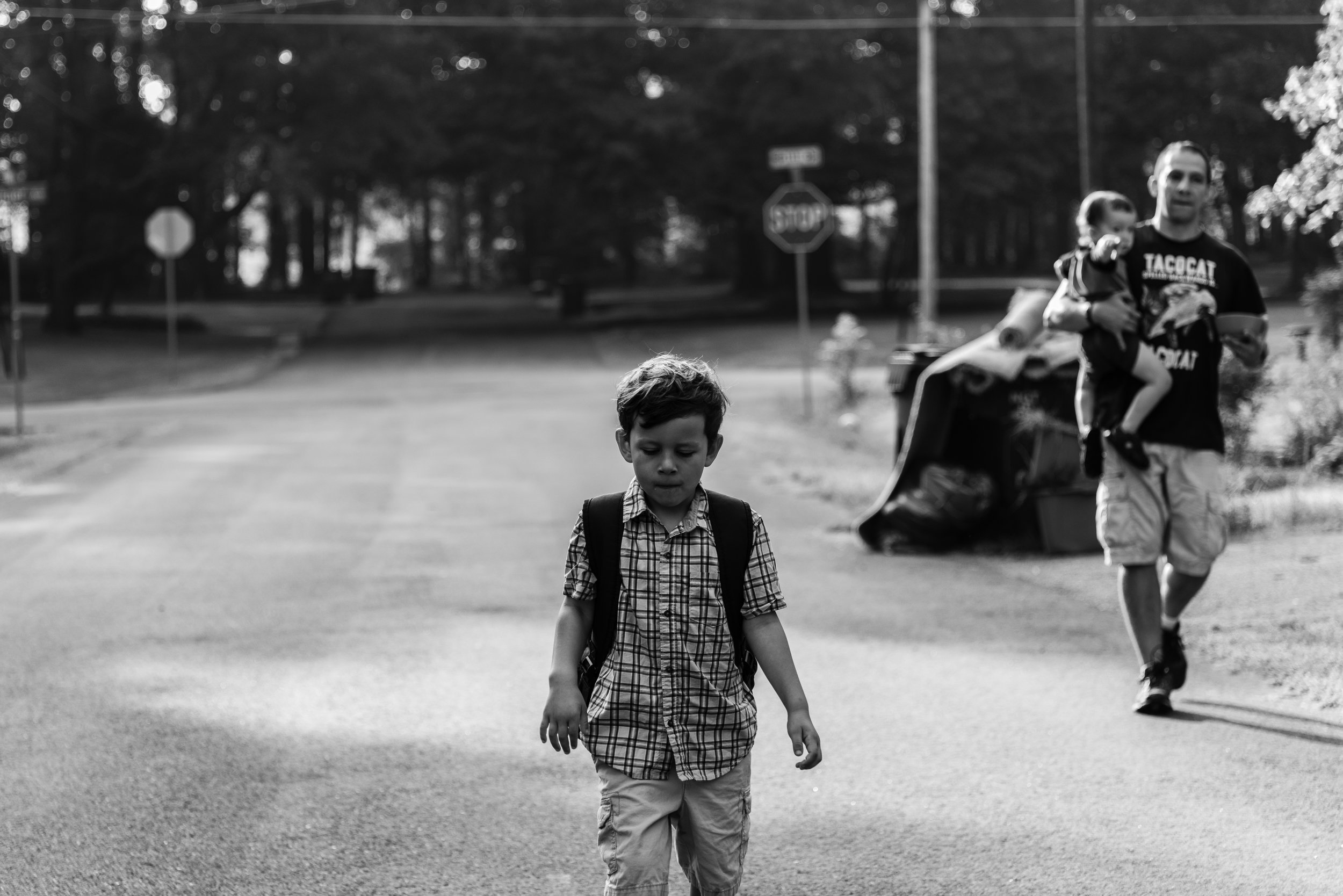 Boy walking to school with dad and baby brother in Northern Virginia by Family Photographer Nicole Sanchez