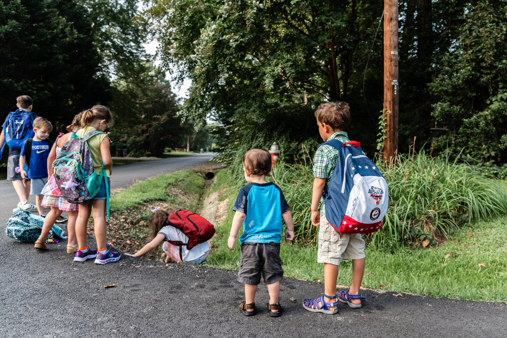 Boy waiting for school bus with baby brother in Northern Virginia by Family Photographer Nicole Sanchez