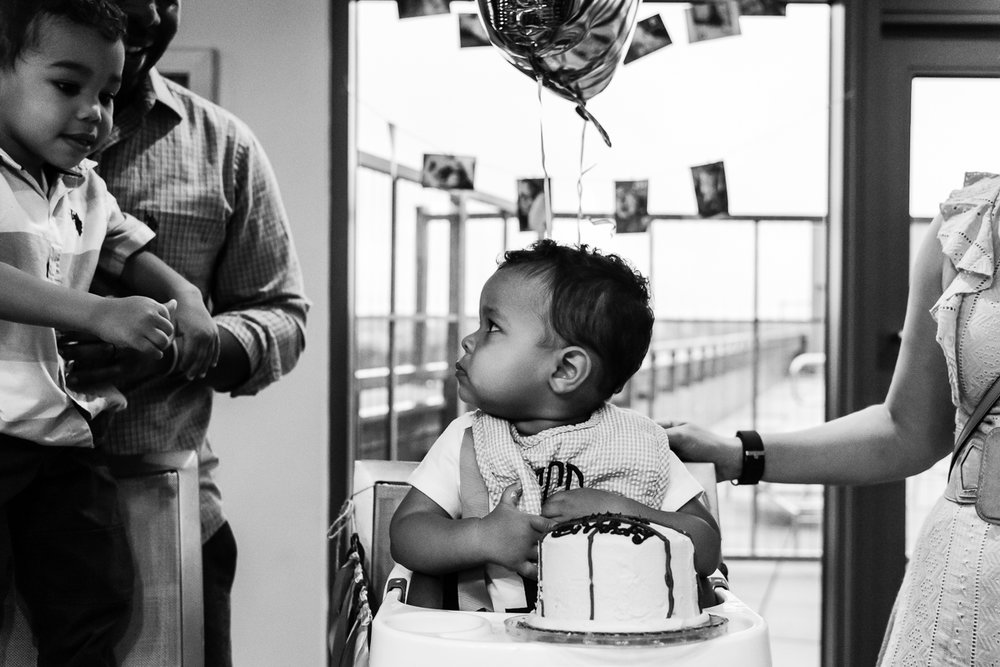 Baby worried about big brother taking his cake by Northern Virginia Family Photographer Nicole Sanchez