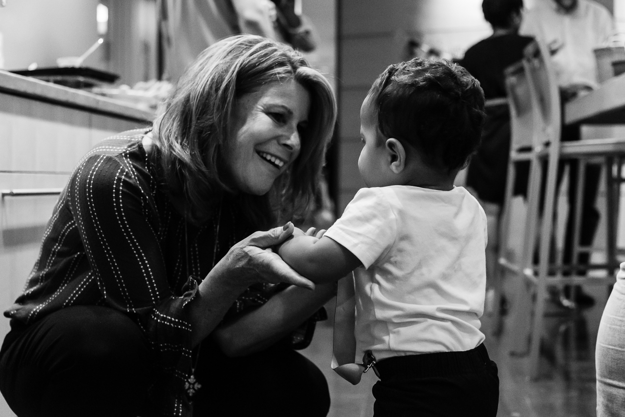 Grandmother smiling lovingly at grandson by Northern Virginia Family Photographer Nicole Sanchez