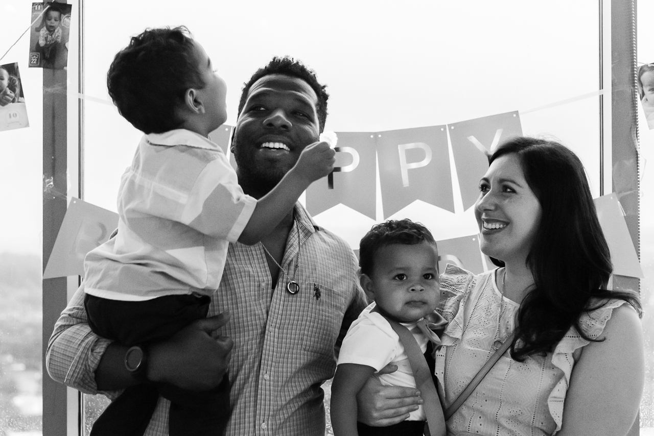 Mom and dad laughing with their kids at birthday party by Northern Virginia Family Photographer Nicole Sanchez