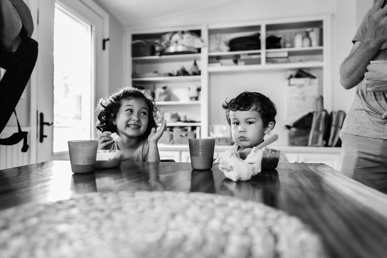 Brother and sister having a snack at kitchen table by Northern Virginia Family Photographer Nicole Sanchez