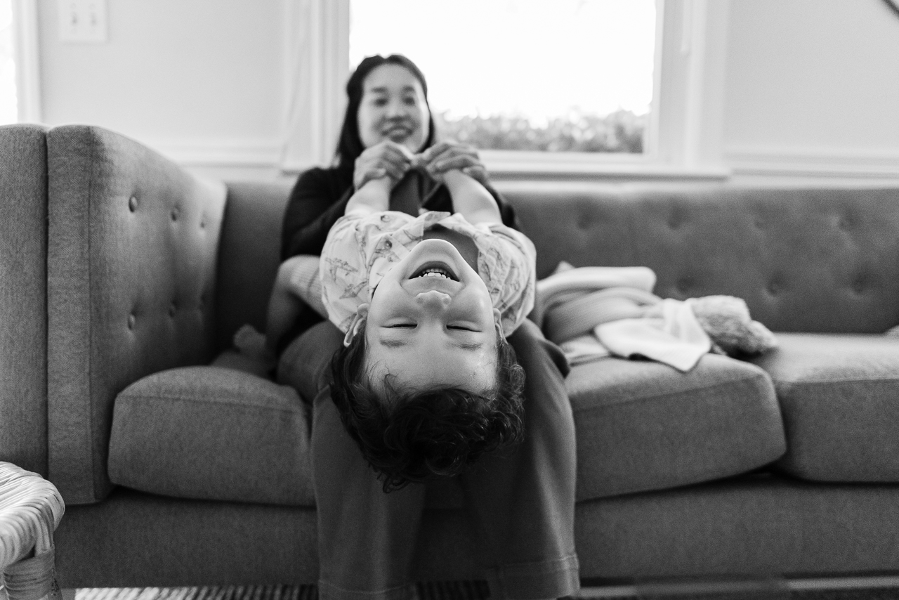 Toddler laughing upside down on mom's lap by Northern Virginia Family Photographer Nicole Sanchez