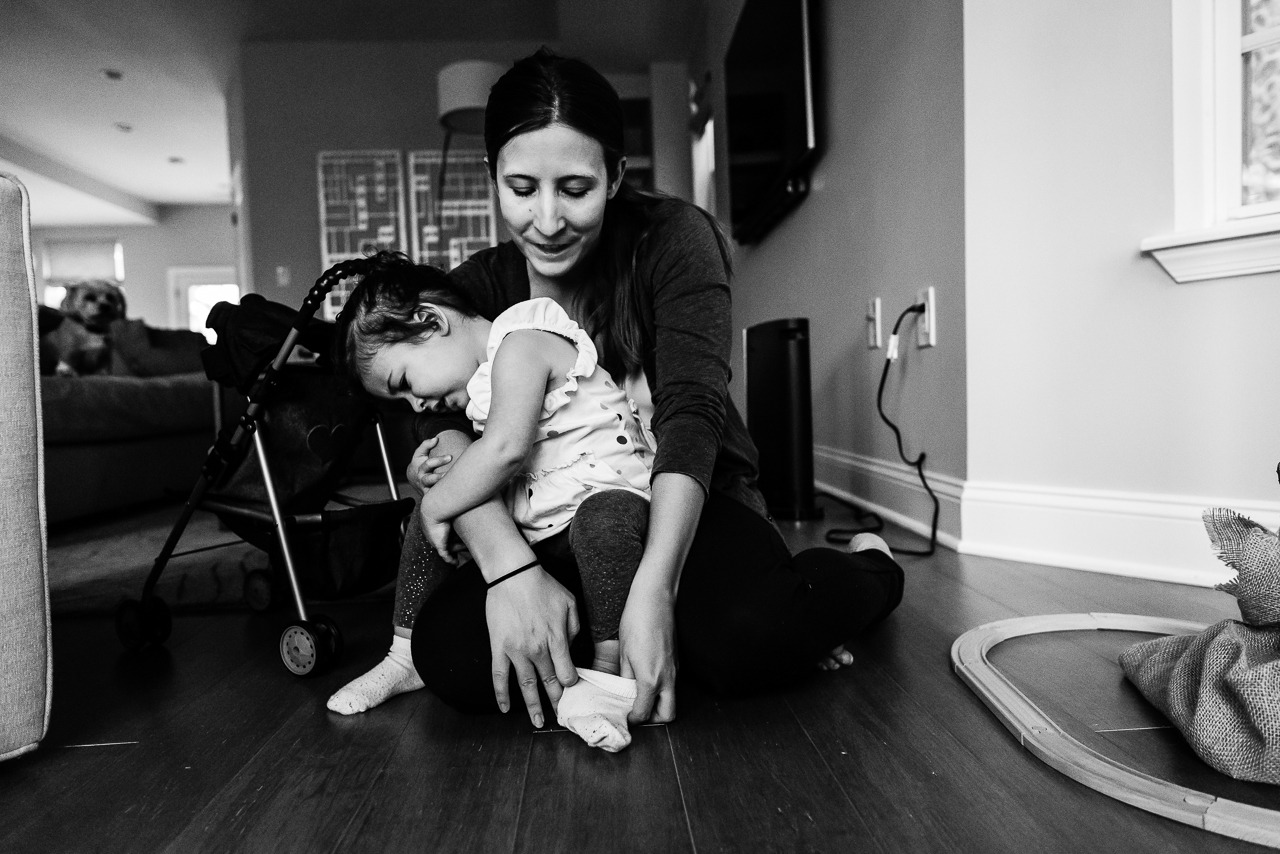 Mom comforting daughter in her lap