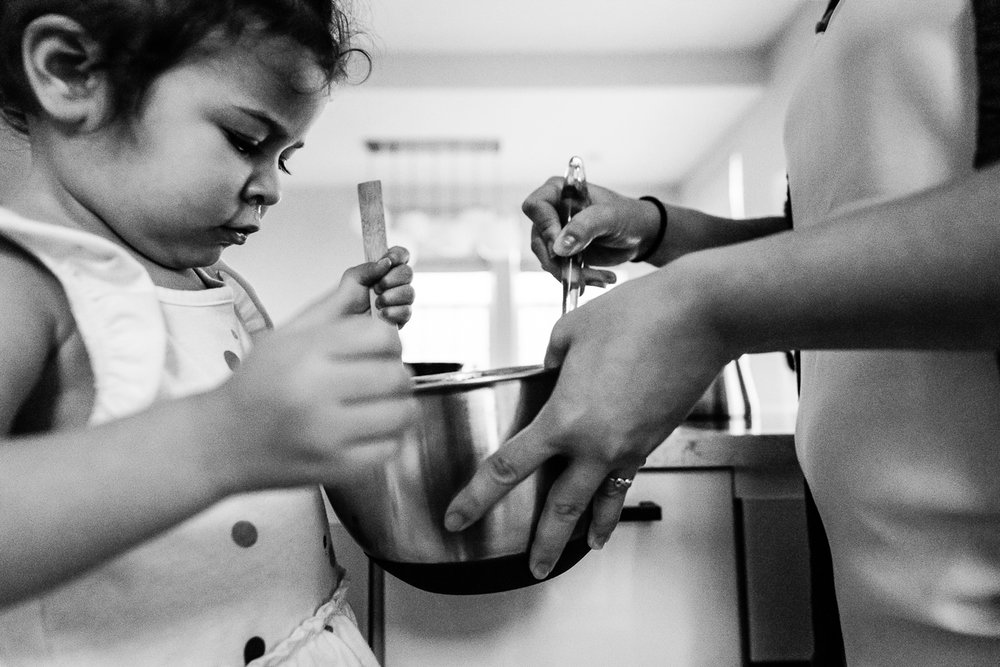 Mom and daughter stirring cookie batter