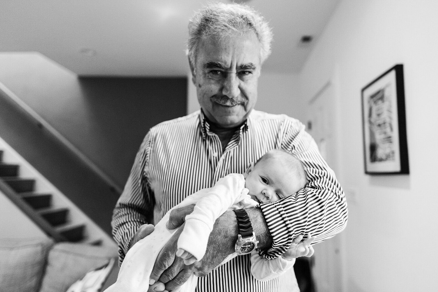 Grandfather holding newborn granddaughter by Northern Virginia Family Photographer Nicole Sanchez